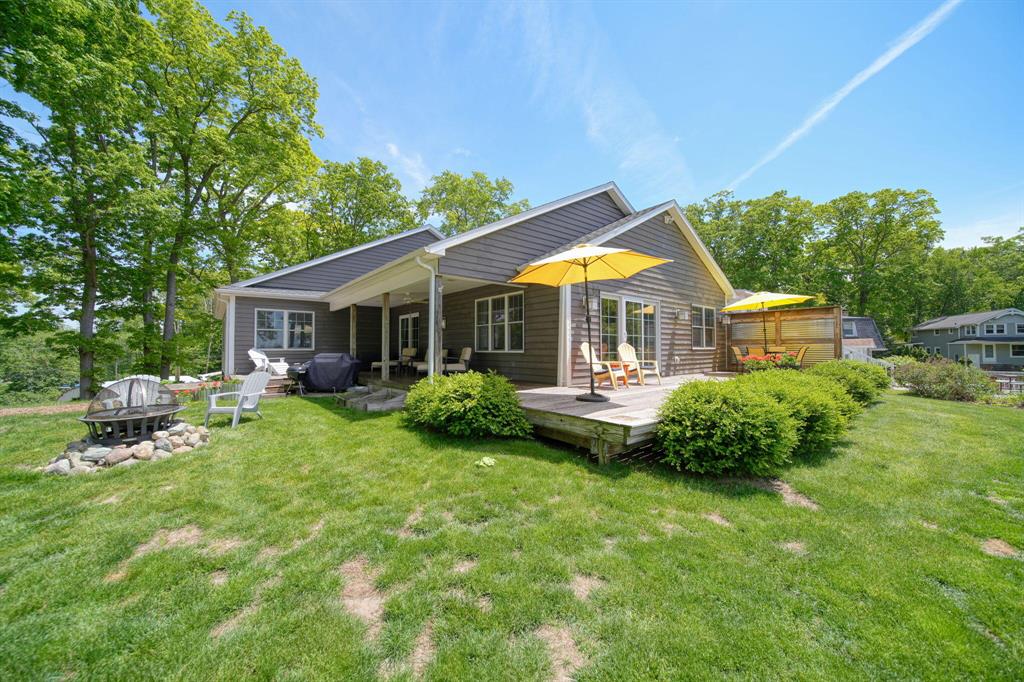 Welcome to 1853 Shady Ln, a breathtaking lakefront retreat in the heart of Michigan's Irish Hills! Situated on .74 acres with an unparalleled 160 feet of pure sandy frontage, this 2015-built home offers over 3,500 sq. ft. of beautifully designed living space with 4 bedrooms, 3 baths, and sunset views that will take your breath away. Inside, enjoy an open floor plan with a top-of-the-line luxury kitchen, featuring quartz countertops, solid wood cabinetry, and high-end finishes. The primary suite is a true oasis, complete with an ensuite bath, in-room laundry, and amazing lake views. Bathrooms feature granite counters and ceramic tile floors, while an extra-wide staircase adds to the spacious feel.Relax in the game room, cozy up by the fireplace, or step outside to the covered porch and expansive deck overlooking the water. A heated 2-car attached garage with a huge screen door adds versatility. Plus, with extensive dock and hardware, easy access to the lake is guaranteed via a gentle hill, perfect for walking or riding. This home is updated, fresh, and priced below appraisal- an incredible value for lakefront living. Don't miss your chance to own this Irish Hills gem!