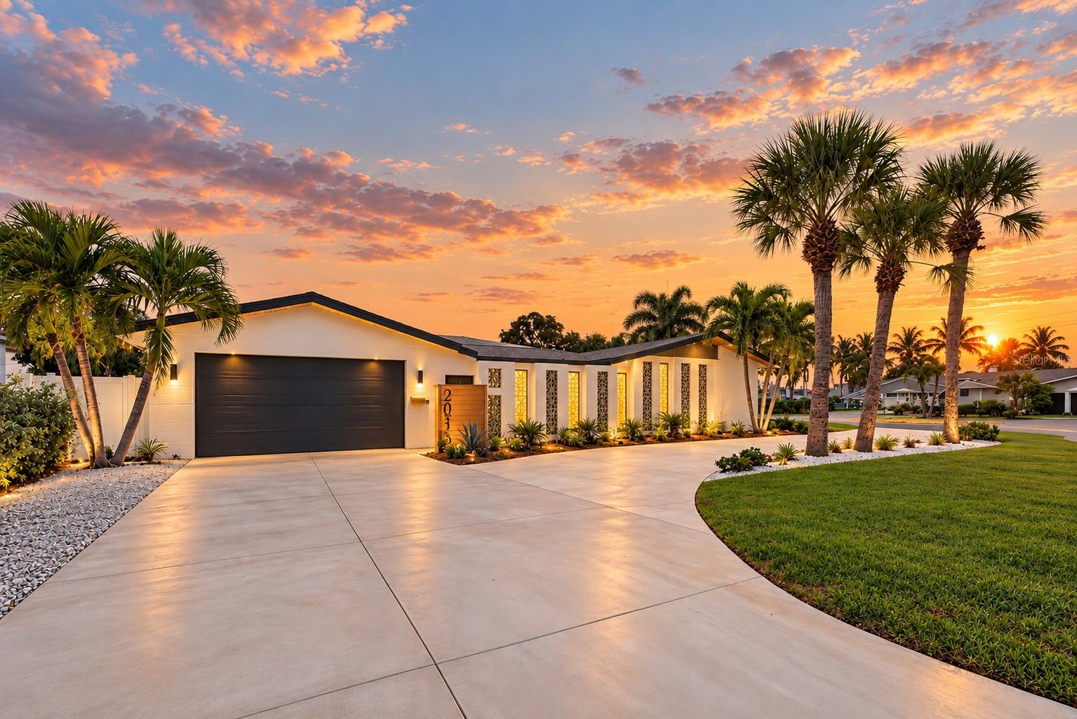 Not All Luxury Needs a Waterfront View. Nestled among multimillion-dollar waterfront estates in coveted Pasadena Golf Club Estates, this extraordinary Mid-Century Modern retreat proves that sometimes the most captivating view is found right in the heart of your own home. Remodeled, refined, and unlike anything else, this isn't simply a home that's been cosmetically updated. It's been thoughtfully and expertly reimagined, inch by inch, blending timeless architectural character with contemporary sophistication. Situated on an expansive corner lot with peekaboo views of Boca Ciega Bay, this stunning 3-bedroom, 3-bathroom residence offers 1,940 square feet of inspired living space where every detail feels intentional. From the moment you arrive, the striking architectural lines, fresh exterior paint, thoughtfully curated landscaping, and brand-new circular driveway create undeniable curb appeal. Step inside, and the design story only gets better. Warm wood tones, beautiful new flooring, designer mid-century-inspired tile, and fresh interior paint set the stage for interiors that feel both sophisticated and inviting. Eye-catching terrazzo pendant lighting draws your attention to the dramatic reeded library wall, while architectural textures and carefully selected finishes create an atmosphere that's effortlessly cool and anything but ordinary. The completely redesigned kitchen is equally impressive, featuring new cabinetry, quartz countertops, beautiful zellige tile, and a matching suite of new stainless steel appliances. The three beautifully updated bathrooms continue the home's distinctive design aesthetic, while two of the three bedrooms feature private ensuite bathrooms. The spacious primary retreat offers an additional layer of privacy and indulgence, complete with a generous walk-in closet featuring custom shelving and a built-in vanity, plus glass sliders leading to a secluded outdoor retreat adjacent to the atrium. And then there's the pièce de résistance. At the very heart of the home, an extraordinary open-air atrium creates a private sanctuary unlike anything you'd expect. Featuring stunning custom noir terrazzo, a gentle cascading waterfall, breeze blocks, and a statement fireplace, this captivating space seamlessly blends architecture, nature, and relaxation. Imagine morning coffee beside the soothing sound of water, intimate evenings around the fire, or simply escaping the everyday without ever leaving home. It's indoor-outdoor Florida living reimagined, and the kind of space that makes every Instagram-worthy moment feel effortless. Beyond its undeniable beauty, this home delivers meaningful improvements where they matter most, including a new 200-amp electrical panel, new water heater, hurricane-impact garage door, epoxy-finished garage floor, EV charger, convenient interior laundry, and fresh paint inside and out. NO HOA and NO CDD add even more appeal. You're within walking distance of charming Downtown Gulfport and its eclectic restaurants, shops, galleries, and waterfront atmosphere. Vibrant Downtown St. Petersburg, St. Pete Beach, and the renowned Gulf beaches are just minutes away, with convenient access to Tampa, Bradenton, and Sarasota. Boating, golf, dining, arts, and culture are all within easy reach. This is more than a beautifully reimagined home. It's a celebration of architectural individuality, inspired design, and Florida living from the fairway to the beach and beyond.