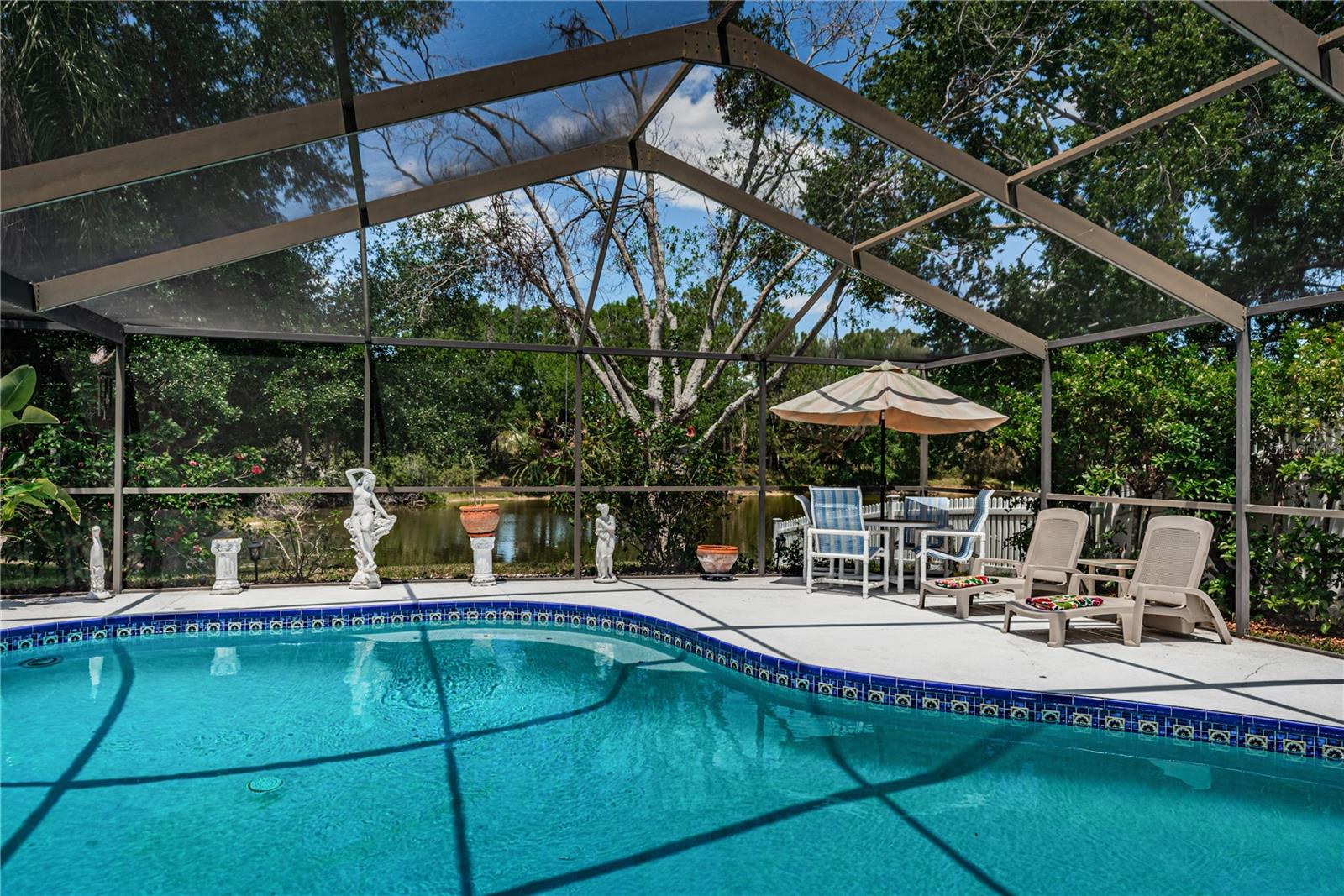 Beautiful pool home overlooks a pond for tranquil views. The covered lanai is ideal for entertaining.  This house NEVER flooded, but is in zone AE so flood insurance is required. An open floor plan makes it feel larger than what it is. The master overlooks the pool and features a huge walk-in closet. The second bedroom also has a walk-in closet. Some windows have been replaced, HVAC was replaced in 2020 and home has been well maintained. The family room has a cozy fireplace and soaring ceilings. Located just 15 minutes to Tampa International Airport and 30 minutes to Gulf beaches, this neighborhood is super convenient. New insurance quotes: flood $5361 hazard $4154.
