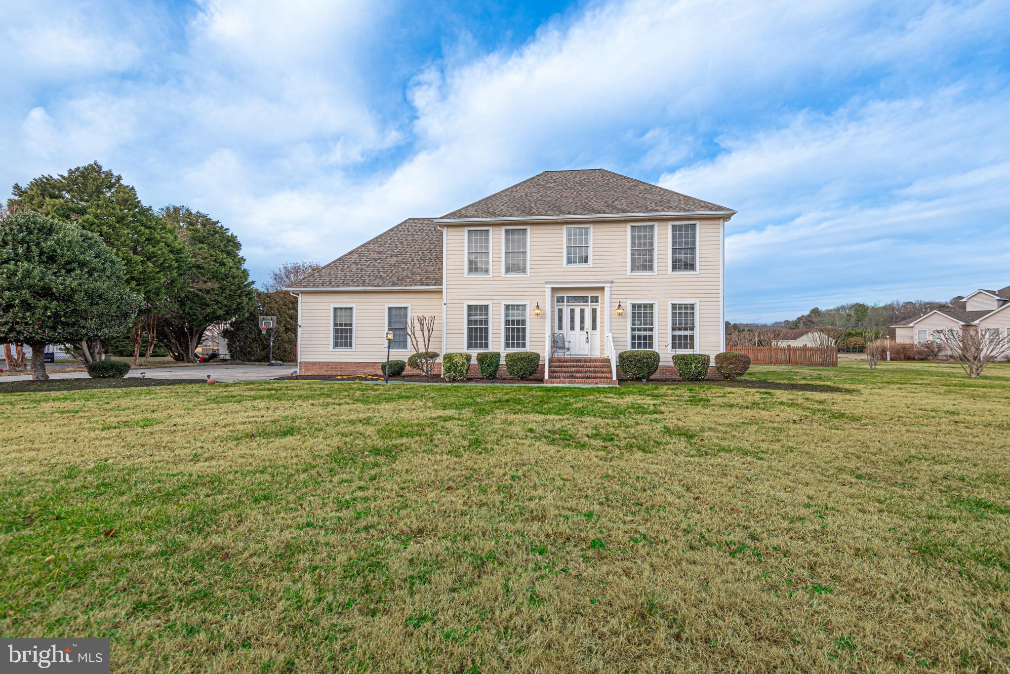 Stunning, spacious Georgian-style home located just 10 minutes from the Ocean City, Delaware beaches and Historic Berlin. Enjoy peaceful rural living while relaxing by your inground pool, all set within a fully fenced one-acre yard.The home features a Hardie-Plank exterior and a side-entry garage with two new garage doors. Inside, you’ll find elegant crown molding, decorative raised wall paneling, custom built-in bookshelves, and a beautifully appointed kitchen with granite countertops and stainless steel appliances. A new heat pump installed in 2025 adds modern efficiency.The first-floor office has been converted into a private in-law suite, ideal as a fifth bedroom, complete with an en-suite walk-in bath. Upstairs offers four generously sized bedrooms and two full baths, including a stunning primary bath with a claw-foot soaking tub and custom marble shower.Additional highlights include a low HOA fee of just $200 annually and NO city taxes—making this exceptional property as practical as it is beautiful.