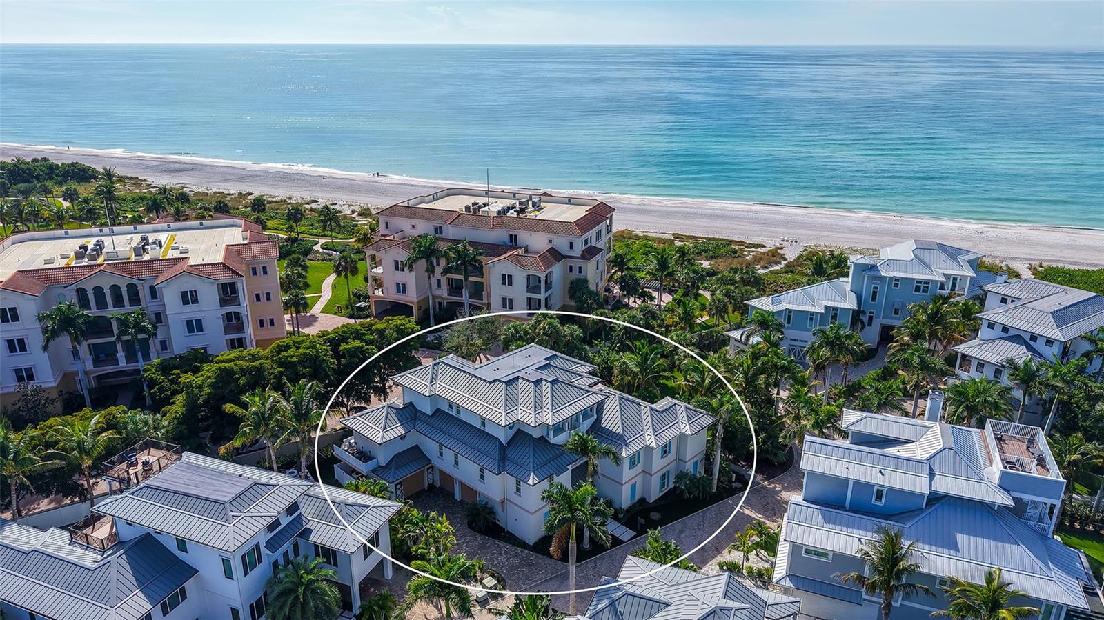 Designed by award-winning architect, John Cooney, and built by Sarasota’s premier coastal homebuilder, Perrone Construction, this mid-Key classic is simply among Longboat Key’s finest homes.Steps from the beach and with expansive Gulf and Bay views, this masterpiece offers more than 4300 square feet of refined interiors on the main living floors together with multiple large lanais and balconies.  A beautiful foyer, large family room, and home gym are featured on the ground floor, along with an oversized three-car garage and storage room.The quality of the home’s design and construction are matched by the charm of the interior finishes and amenities.  The living areas incorporate beautiful ceiling elevations, along with custom wide-plank hardwood, Italian porcelain tile, and custom plantation shutters and drapes.  The Great Room flows into the chef’s kitchen which features custom cabinetry, quartz countertops, Wolf and SubZero appliances, and a temperature-controlled 275 bottle wine room.  Designed for easy entertaining, the Great Room opens onto a large lanai with its gas fireplace and grill, and gorgeous Gulf and sunset views.  Adjoining the kitchen is a perfect dining room with its own balcony and Gulf views, as well as a large family office/bonus room with custom cabinetry and bookshelves.  The Lutron system controls both the lighting and the custom drapes and shades.  The home’s elegant chandeliers and sconces bathe its interior with gracious warmth.The beautiful master suite on the main floor includes a bedroom cathedral ceiling and access to the outdoor lanai.  The master bath features custom cabinetry, porcelain tile, a large steam shower, and is plumbed for a master bathtub.Three spacious guest suites, a gathering lounge, and balconies with Gulf views are found on the second living floor.  A private elevator connects all levels.Both the home and exterior grounds are designed for year-round, low-maintenance living.  An extensive landscape refresh in 2023 included new turf and lighting, an outdoor shower, and a great fire pit area for entertaining.  Lush landscaping and a tranquil pool setting provide both screening and privacy.  The home features remote controlled screening and storm shutters, extensive use of Azek composite, and other low-maintenance materials, along with a gas generator, whole-house water filtration system, central vacuum, and much more.With miles of pristine beach and bay to explore and with the abundant cultural, dining, and shopping amenities of Sarasota, St. Armand’s Circle, and Anna Maria Island nearby, this timeless home delivers the very best of Longboat Key living.