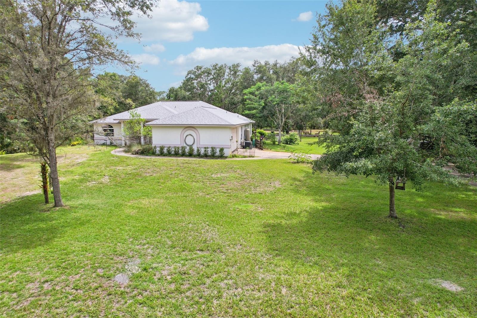Peaceful Country Living with City Convenience!
Tucked away on a quiet dead-end street, this private 3-bedroom, 2.5-bath pool home offers the perfect blend of serene rural charm and modern accessibility. Set on just under 2 acres with no HOA or CDD, this property is ideal for outdoor enthusiasts, hobby farmers, or horticulturists alike.

The home features 1,823 sq ft of well-planned living space, including a guest suite for added flexibility. Enjoy evenings by the outdoor firepit, or work on projects in the spacious workshop. The 2-car side-entry garage provides ample parking and storage.  New home updates to include new roof (2024), A/C (2021), pool pump motor (2024) & $10K worth of hurricane window replacements.  Included is an energy feature with solar hot water heater panels that will convey with the home at no extra cost.  Easily keep dirt & dust from accumulating with the home's centralized vacuum system.

Bring your farm animals—they're welcome here! Whether you're gardening, relaxing by the pool, or simply soaking in the peaceful, country setting, this property is a rare find. Conveniently located near shopping, major interstates, and just steps from a charming country church.

Don’t miss this rare opportunity for true country living with big city conveniences!