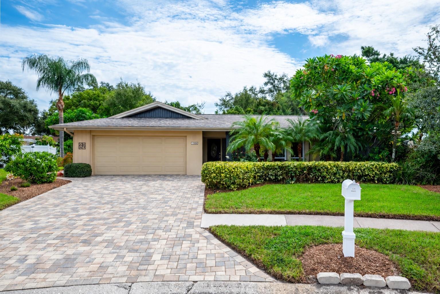 Step into your own private paradise with this rare, move-in-ready gem nestled on a serene, quiet cul-de-sac with zero through traffic in the highly sought-after Oakhurst community of Century Oaks—where homes are selling in a single day! Set on an expansive, park-like, and supremely private woodland lot, this immaculate 3-bedroom, 2-bath residence boasts a bright, flexible split floor plan, an inside laundry room with large storage closet, an oversized 2-car garage, and multiple sliding glass doors that frame captivating nature views. The heart of the home features a chef's kitchen outfitted with rich granite counters, updated cabinetry, a brand-new stainless steel refrigerator, and a unique pass-through window opening directly to the expansive covered lanai and caged pool area featuring elegant pavers and ample conversation space. Beyond the pool enclosure lies a breathtaking, fully sequestered backyard complete with a butterfly garden, tranquil fountain, secluded seating area, and endless space that can easily be cleared for family lawn games, plus a generous side yard with storage, Wally Watt shed & potting area and potential small boat parking. The serene primary suite offers a private retreat with dual closets, an en-suite bath with a classic Roman tub, and direct pool access. The opposite wing of this well designed Rutenberg home features, an expansive 15 foot room which currently acts as a sumptuous dining room, but could easily serve as a vibrant family room. Off of it are two additional ample bedrooms plus the laundry leading to an oversized 2 car garage, PLUS a fully updated pool bath with custom shower. Situated just 1.5 miles from pristine Gulf beaches and a quick half-mile to top schools and shopping, this immaculate home also includes a newer roof, updated A/C, and top-tier upgrades throughout, making it an extraordinary, once-in-a-lifetime coastal sanctuary ready for its lucky new owners!