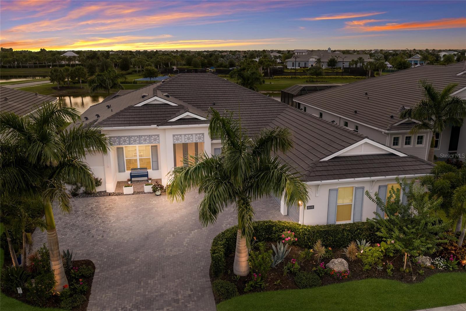 Experience refined LUXURY in this exceptional 4 bedroom, 4.5 bath, 3 car garage Maxwell floor plan by Toll Brothers, offering 3,600 square feet of thoughtfully designed living space in the highly sought-after community of The Isles at Lakewood Ranch. This stunning single story residence welcomes you with soaring ceilings, CUSTOM wall accents in the grand foyer, and breathtaking views through EXPANSIVE sliders to the resort-style pool and tranquil pond beyond. The open concept floor plan is designed for both everyday living and elegant entertaining, featuring a spacious great room with CUSTOM BUILT-IN cabinetry and shelving, TRAY ceilings accented with beautiful wood style beams, and seamless indoor-outdoor flow. At the heart of the home is a chef’s dream kitchen showcasing shaker style cabinetry with glass front details, tile backsplash, stone countertops, built-in oven and microwave, cooktop, stainless steel hood, premium stainless steel appliances, and an oversized island with a dual stainless steel farmhouse sink and generous seating. The impressive WALK-IN PANTRY, customized by Clive Daniel, provides great organization and storage. Adjacent to the kitchen, the dining room features additional built-ins, a striking accent wall, and corner sliders that fully open to the lanai, creating an effortless connection to the outdoor living space. The private den offers custom built-in desks and cabinetry, creating the perfect executive office or flex space. The LUXURIOUS primary suite is a true retreat, featuring direct access to the lanai and a spa-inspired bath with oversized split vanities, a dedicated makeup station, a large walk-in glass-enclosed shower, and a relaxing garden tub. Custom designed closet systems throughout the home provide both elegance and exceptional organization. Three additional bedrooms are thoughtfully positioned on the opposite side of the home, with private ENSUITE baths, while a stylish powder bath serves guests. The spacious laundry room is equally impressive with ABUNDANT cabinetry and a utility sink. Outdoor living reaches new heights with an EXPANSIVE SCREENED lanai featuring a spectacular HEATED SALTWATER POOL and SPA, including a 22x44 pool, 8x10 spa, sun shelf, CLEAR VIEW SCREENING for unobstructed sunset views, and a SUNSETTER AUTOMATIC SHADE for additional comfort. Beautiful landscaping, ceiling fans throughout, an EXTENDED driveway, overhead garage STORAGE RACKS, and HURRICANE IMPACT-GLASS WINDOWS further enhance the home’s appeal. Residents of The Isles enjoy an outstanding collection of amenities including a clubhouse, resort-style pool with cabanas, state-of-the-art fitness center and wellness studio, tennis and pickleball courts, half basketball court, playground, dog park, fishing pond, dock, and scenic walking trails. Perfectly situated just minutes from the Sarasota Polo Club, Waterside Place full of boutique shopping, restaurants and weekly farmers markets, the UTC Mall and shopping area, the Sarasota-Bradenton International Airport, and the Gulf Coast's FAMOUS BEACHES, this EXTRAORDINARY residence offers an unmatched blend of luxury, comfort, and location. Don't wait to make this your HOME and begin your FLORIDA Lifestyle!