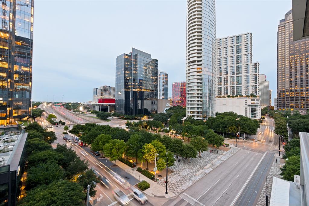 Wake up to Klyde Warren Park views every day in this corner residence at Parkside, one of downtown Dallas's most scenic condo addresses. Floor-to-ceiling windows, 10-foot ceilings, and automated shades frame park and skyline views from the living room to the primary suite.The kitchen features professional-grade appliances: a Wolf range, oven, and microwave, a Sub-Zero refrigerator and freezer, Bosch dishwasher, and Poggenpohl cabinetry, finished with new 2026 quartz countertops and sink. The entire home was fully renovated in 2026, including refinished hardwood floors, new tile, Level 5 paint, updated lighting and hardware, and a primary bathroom rebuilt with a soaking tub and open walk-in shower.Both bedrooms include California Closets systems and blackout shades. A flexible bonus room suits a home office, media room, or guest suite. The floor plan includes two full bathrooms, a powder bath, and a full-size laundry room.A rare, oversized private patio sets this unit apart from other downtown Dallas condos. Major systems are updated: dual heat-pump HVAC (2022), new water heater (2023), and a Jeep EV charger (2024) at one of three deeded parking spaces, plus a private storage unit.Building amenities include a rooftop lounge with a full kitchen, fob-entry security, elevator access, and gated parking. The location scores a 93 Walk Score, minutes from the Perot Museum, Dallas Museum of Art, Nasher Sculpture Center, and Uptown Dallas dining and shopping.This address sits inside Dallas's growing Y'all Street financial district. The Bank of America Tower at Parkside, slated to house the Texas Stock Exchange's Texas Market Center, opens next door in 2027 as more financial firms relocate downtown — a strong fit for finance professionals seeking walkable access to work and culture.Condos with this view, renovation, and location move quickly. Contact your agent to schedule a private showing.