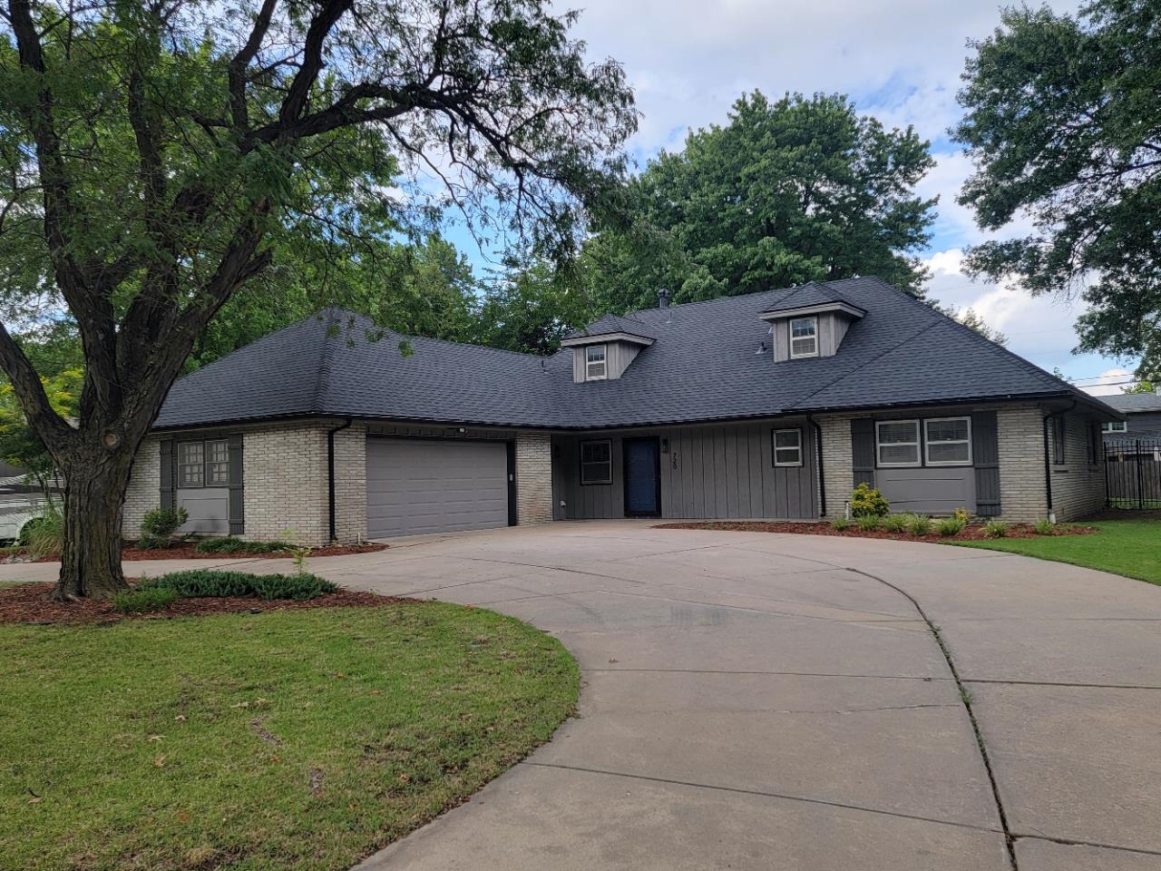 One of the most sought-after zip codes in Wichita.  Beautiful mature tree lined streets and pride of ownership.  Welcome to this magnificent home situated on a nice lot with a circle driveway.  Step into the home which features freshly painted walls and beautiful all new flooring.  The large main floor family room has a great stone gas fireplace and wet bar.  The informal and formal dining areas are perfect for dinner gatherings.  The updated kitchen has granite countertops and back splash and a large island with a built-in cook top and oven (all appliances stay).  There is also a very nice 1/2 bath just off the laundry room.  Upstairs is a huge master suite with walk-in closet, an office with built-in desk and bookshelves, which could also make another great closet space if you want. Best of all check out the master bath and the beautiful tile shower with dual shower heads!!  This beautiful home truly is a must see and in a wonderful neighborhood close to everything!  The backyard is fenced and has a nice patio area great for those cookouts.  Roof is brand new and master AC unit is new.  Hurry this one will not last.