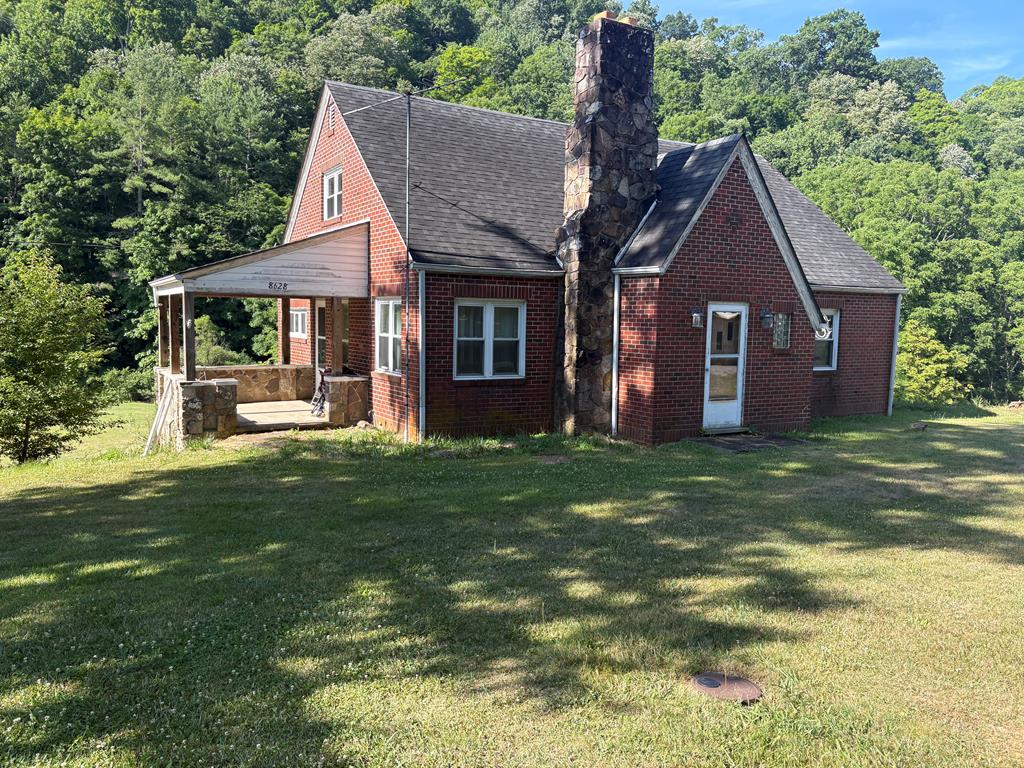Charming 1947 brick home full of character nested on 2.34 acres across three parcels in Bland Va.  This well-built two-story home offers 1706 sq ft of living space with 10 rooms total, including 5 bedrooms and 2 full baths, plus a full unfinished basement offering great potential.  Original hardwood floors and beautiful wooden banisters add timeless charm throughout.  Cozy up by the fireplace on chilly evenings, and outside you can enjoy the peaceful sound of Crab Orchard Creek running along the back of the property.  A wooded section past the creek adds privacy and natural beauty, while a paved road and easy interstate access make this rural retreat surprisingly convenient.  Sold AS-IS - a wonderful opportunity to make it your own.  Schedule your showing today!