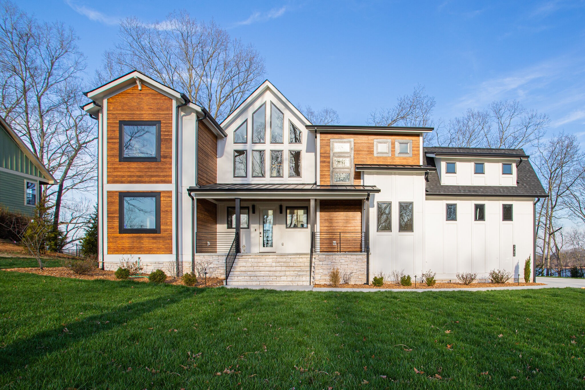 This modern and upscale lakefront property on Tims Ford Lake is one you do not want to miss! From the bold architectural finishes and modern design to the functionality and lakeview retreat this place is one to call home. The main home offers 4 bedrooms and 3.5 baths with a beautiful, stacked stone fireplace and natural stained hardwood floors, a gourmet kitchen & media room, and an attached 1-car garage. Walk out the back door into the screened in lakeview oasis with patio, fire pit, & hot tub. The 2-car detached garage offers a separate apartment above with a full bedroom, bathroom and closet- perfect for those who love to have guests over. This home comes with its own deeded boat slip and boat lift. Community pool and clubhouse located here in the Fanning Bend neighborhood. This home has it all.