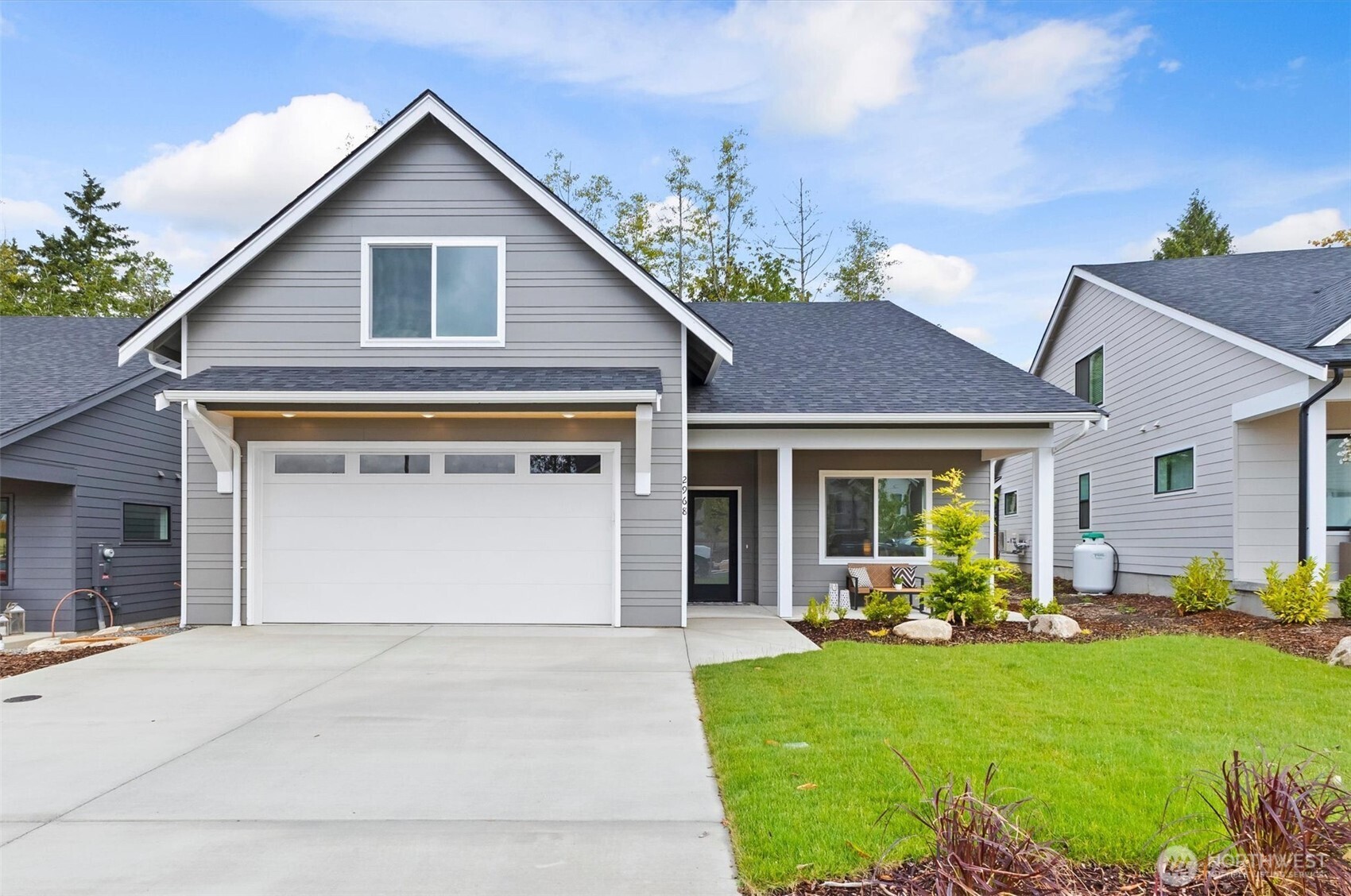 Blaine, WA | 4BD / 3BA | $5,000 Seller Credit + Lender Incentives Welcome to The Ridge, where thoughtful design meets everyday livability. This 4-bedroom home offers a layout that works as hard as you do, with room to grow, gather, and settle in. The heart of the home is a stunning open concept kitchen and living area featuring flat panel cabinetry, quartz countertops, upgraded appliances, and a propane fireplace that makes every evening feel intentional. Underfoot, a premium engineered hardwood floor for an warm & cozy vibe. The main floor primary suite is a true sanctuary with a double vanity, tile walk-in shower, large walk-in closet, and abundant natural light. A flexible fourth bedroom on the main level works beautifully as a home office or guest room. Upstairs, two additional bedrooms and a generous bonus room adapt to whatever life calls for, whether that's a gym, gaming room, or creative studio. Step outside to a huge covered back deck made for year-round enjoyment. Park with ease knowing an EV charger is already waiting in the garage. Highlights buyers love: main floor primary suite and home office option, bonus room upstairs for ultimate flexibility, premium engineered hardwood floors, EV charger in garage, covered back deck. $5,000 seller credit plus lender incentives available. Minutes to downtown Blaine, I-5, and the Canadian border. Schedule your tour today!