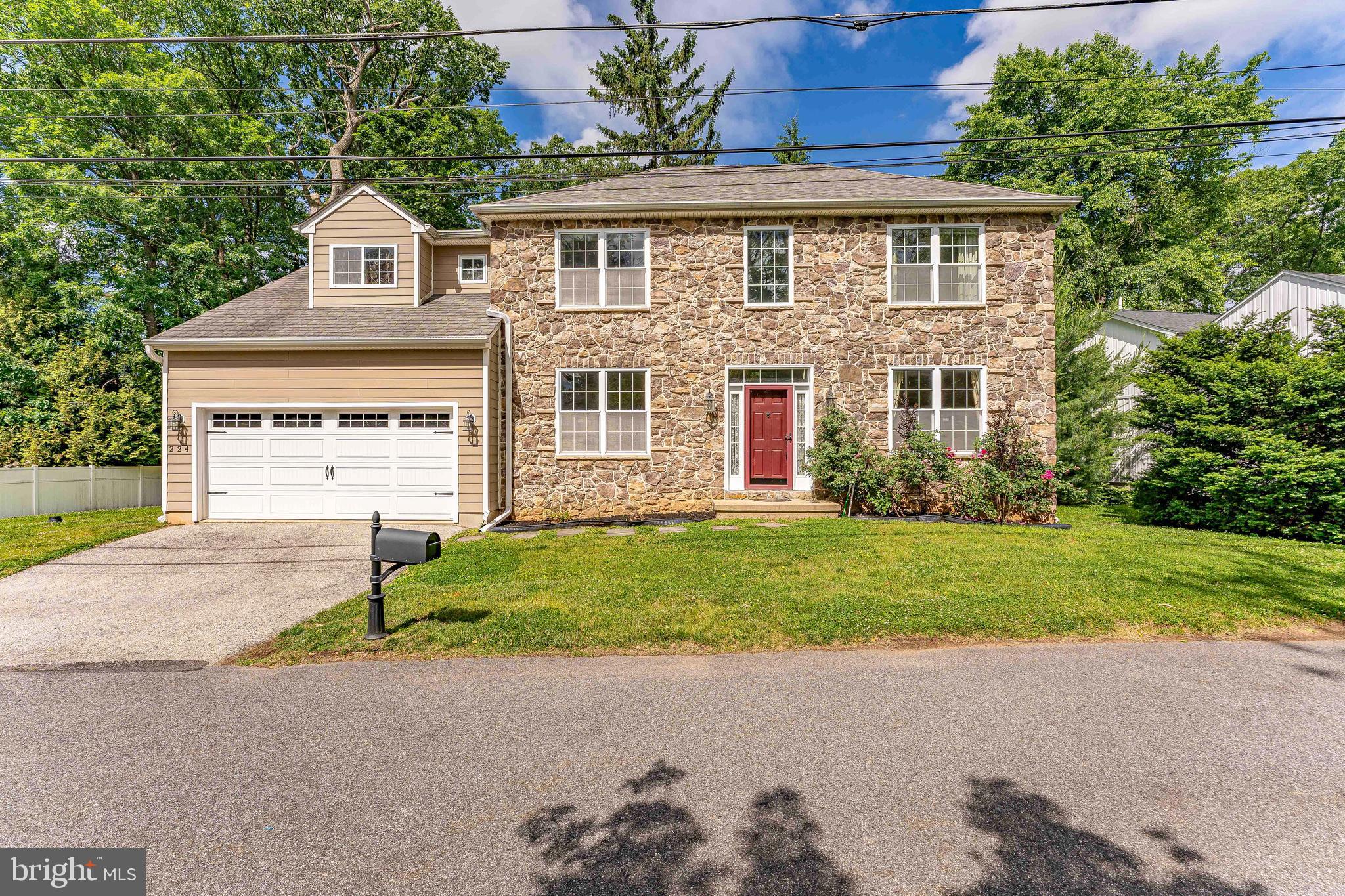 Welcome to 224 Hearn Avenue, a 4-bedroom, 2.5-bathroom single family home in Berwyn, located within the award-winning Tredyffrin-Easttown School District. Offering spacious living areas, timeless finishes, and a functional layout, this home is designed for both everyday living and effortless entertaining. As you approach the home, a 2-car garage and 2-car driveway provide ample parking and lead to the inviting front entrance. Step inside to a dramatic two-story foyer featuring hardwood floors, a chandelier, chair rail with wainscoting, and access to a convenient powder room and coat closet. To the left, the private home office offers hardwood flooring and a bright double front window, creating the perfect work-from-home space. To the right, the formal living room features hardwood floors and abundant natural light, with an arched entry leading into the elegant dining room. The dining room is highlighted by hardwood flooring, an octagonal tray ceiling, crown molding, and chair rail with wainscoting, providing a beautiful setting for hosting family and friends. At the heart of the home is the well-appointed kitchen, featuring tile flooring, granite countertops, an island with seating, a gas cooktop with a range hood vented to the exterior, a pantry closet, and a double sink. The kitchen opens to the breakfast room, complete with tile floors, a chandelier, and a half wall overlooking the family room, creating an open and connected feel throughout the main living spaces. Just off the breakfast area, the laundry room includes tile flooring, a utility sink, washer and dryer, home alarm system controls, and convenient access to the garage. The family room serves as a warm and inviting gathering space with hardwood floors, a semi-vaulted ceiling, ceiling fan with light, and a stunning floor-to-ceiling stone fireplace and a perfect TV niche. A door from the family room leads to the composite deck, offering a convenient outdoor retreat for relaxing or entertaining while overlooking the backyard. Upstairs, the spacious primary suite features a double-door entry, tray ceiling, ceiling fan with light, carpeting, and a large walk-in closet. The luxurious en-suite bathroom includes tile flooring, a private water closet, double sink vanity with granite countertops, a tiled step-in shower with bench seating, a tiled jetted soaking tub, a linen closet, and a second walk-in closet. Three additional bedrooms, all with carpeting, provide comfortable accommodations for family, guests, or additional office space. A full hall bathroom with tile flooring, a single sink vanity, and a tub/shower combination completes the second level. The finished lower level offers exceptional flexibility with a large recreation room, making it ideal for a media room, play area, home gym, or additional gathering space. A utility room provides added storage and functionality. Conveniently located near local shopping, grocery stores, restaurants, entertainment, and more, this home offers the perfect combination of comfort, style, and convenience. Don't miss the opportunity to make 224 Hearn Avenue your new home.