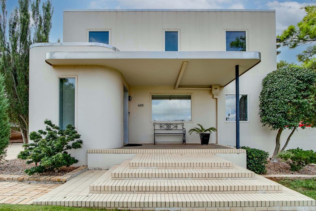 No matter your political views, we can all agree that the views of Oklahoma's State Capitol grounds are unlike anywhere else in the 405.  You'll understand the special significance of the home from the minute you arrive.  Streamline Moderne (a style evolved from Art Deco) meets modern conveniences and updates without making the home feel too modern or contemporary.  The open living/dining/kitchen area makes entertaining 5 or 50 a breeze.  Modern appliances and finishes meld perfectly with the clean lines and original stainless details you'll see throughout the home.  A large office/flex space and 1/2 bath are also on the main floor along with access to the garage.  There are two staircases to the upper floor, with one going to a guest room/office with full bath and the other leading to the incredible primary suite.  Amazing closet and storage space, breathtaking views from the rooftop, and a stunning bath make this retreat the space that dreams are made of.  On the lower level of the home you're invited into a large living space with bar, bedroom, full bath, and huge utility space.  Speakeasy meets modern living in this wonderful space.  Pool table?  Den?  Creative space?  You decide.  And just when you think the front views and stunning interior can't be beat, just head out to the home's backyard.  There you're greeted by lush landscaping, an outdoor fireplace and wow-factor 10x50 lap pool.  This is a special home for a special buyer(s) and the opportunity to own one of the city's most iconic properties is a rare treat.