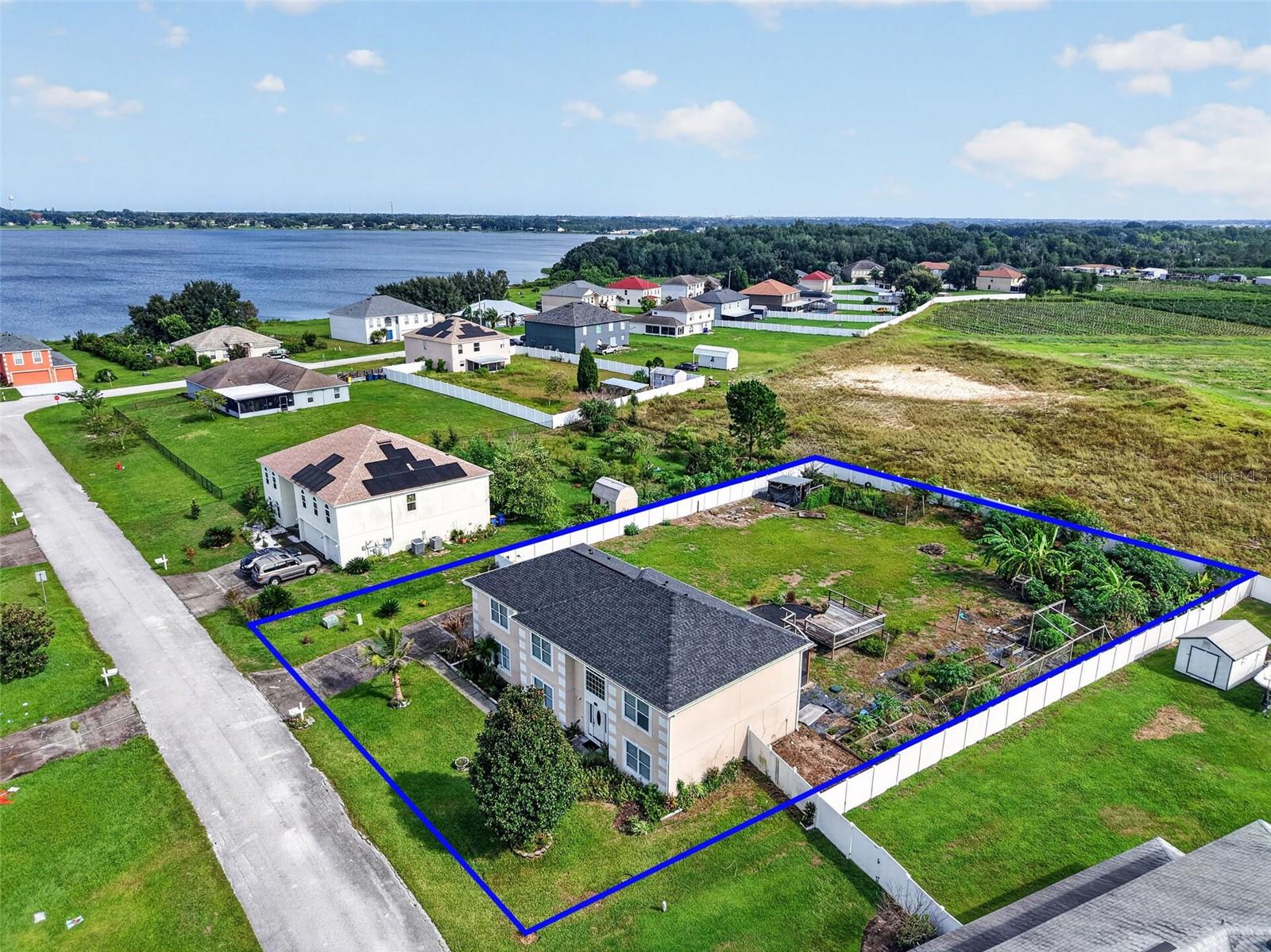 Virtually Staged. Enjoy true Florida tranquility with this move-in-ready 5-bedroom/2.5-bathroom/almost 3,000 square foot home on 1/2 acre! This versatile floor plan offers a thoughtful layout on both levels. On the first floor, you'll find a formal living room, a formal dining room, a comfortable family room, a powder room, and an open kitchen with 3 pantries, offering plenty of storage space. The second floor opens up to a spacious loft. The primary suite includes two walk-in closets and a separate garden tub and shower. Three additional bedrooms, a full guest bathroom, and the indoor laundry round out the rest of the second floor. The 3-car garage faces the side of the home. Outside, the newer (2023) covered, screened lanai is the perfect space to enjoy the outdoors in any weather! Its beautiful pergola-style wood accents and patterned tile floor make this an aesthetically pleasing and functional part of the home. An additional covered area (2022) can be used as an outdoor kitchen or hobby space. The HUGE yard is fully fenced and provides endless possibilities for creating your ideal and private Florida oasis! Enjoy the peace of mind that comes with a NEW roof (2025), a newer HVAC unit, a newer range, an irrigation system that uses well water (public water for the interior of the home, but no additional cost to irrigate the lawn), and a water filtration system for the home! Eagle Lake is a growing area where this type of serenity on a large property will become increasingly rare to find, so claim your slice of paradise before it is gone!