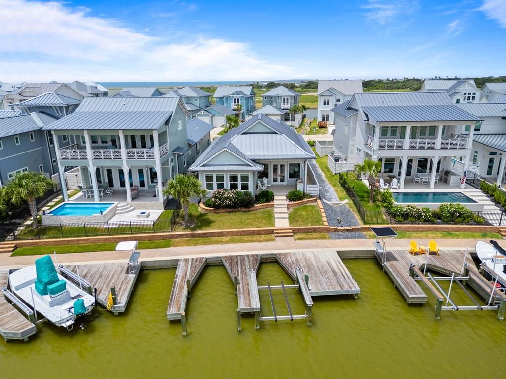 150 Foxtail Lane, where luxury and effortless coastal living come together in one exceptional waterfront retreat. This immaculate single-story home offers 3 bedrooms, 2 bathrooms, and TWO boat slips one with a lift. Designed with boating enthusiasts in mind, the property features an oversized private dock complete withtwo boat slips making it easy to keep multiple vessels ready for a day on the water. A dedicated tackle room provides the perfect space to organize fishing gear, while the detached garage offers abundant storage for vehicles, water toys, and equipment. The outdoor living is just as impressive. With an out door kitchen for cooking and dining al fresco. A spacious front yard welcomes guests, while the expansive rear porch is perfectly positioned to capture spectacular eastern sunrises over the canal. Whether you're enjoying your morning coffee, entertaining friends, or envisioning the addition of a custom pool, this backyard offers endless possibilities. Located within one of Rockport's most desirable gated waterfront communities, residents enjoy outstanding amenities including a resort-style swimming pool, more than two miles of scenic boardwalks, and a community fishing pier that's ideal for casting a line or taking in unforgettable coastal sunsets. Whether you're searching for a full-time residence, weekend getaway, or waterfront investment, 150 Foxtail Lane delivers the boating lifestyle, community amenities, and coastal charm you've been dreaming of. Just bring your boat, your fishing gear, and start making memories on the water. Never been used as a short term rental so it's lovingly been vacationed in, however, if you're looking for income potential from this investment, this home is ready to go.
