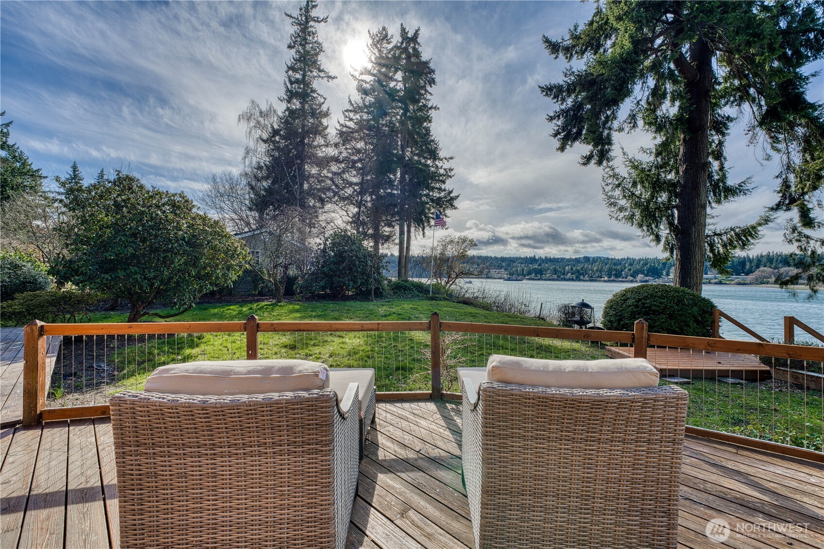 **Luxury Waterfront Living Without Leaving the City**    Experience 80 feet of no-bank Oyster Bay waterfront with breathtaking, unobstructed views of the water and surrounding mountains. This beautiful home features an open kitchen perfectly positioned to capture the stunning bay scenery, creating an ideal space for everyday living and entertaining.    The primary suite offers a private bathroom, with two additional bedrooms upstairs for guests. A versatile lower-level room with its own entrance is perfect for a home office, media room, or workout space.    Relax on the expansive deck while watching the tides roll in, or step down to your own beach just seconds away. Located in a welcoming waterfront community, you're only minutes from the ferry and highway—making this peaceful retreat incredibly convenient.    Be sure to **watch the video footage and time lapse of the bay below** to experience the beauty of this waterfront home and its incredible setting.    **$10,000 concession offered for new kitchen and dining room flooring with a full-price offer.**