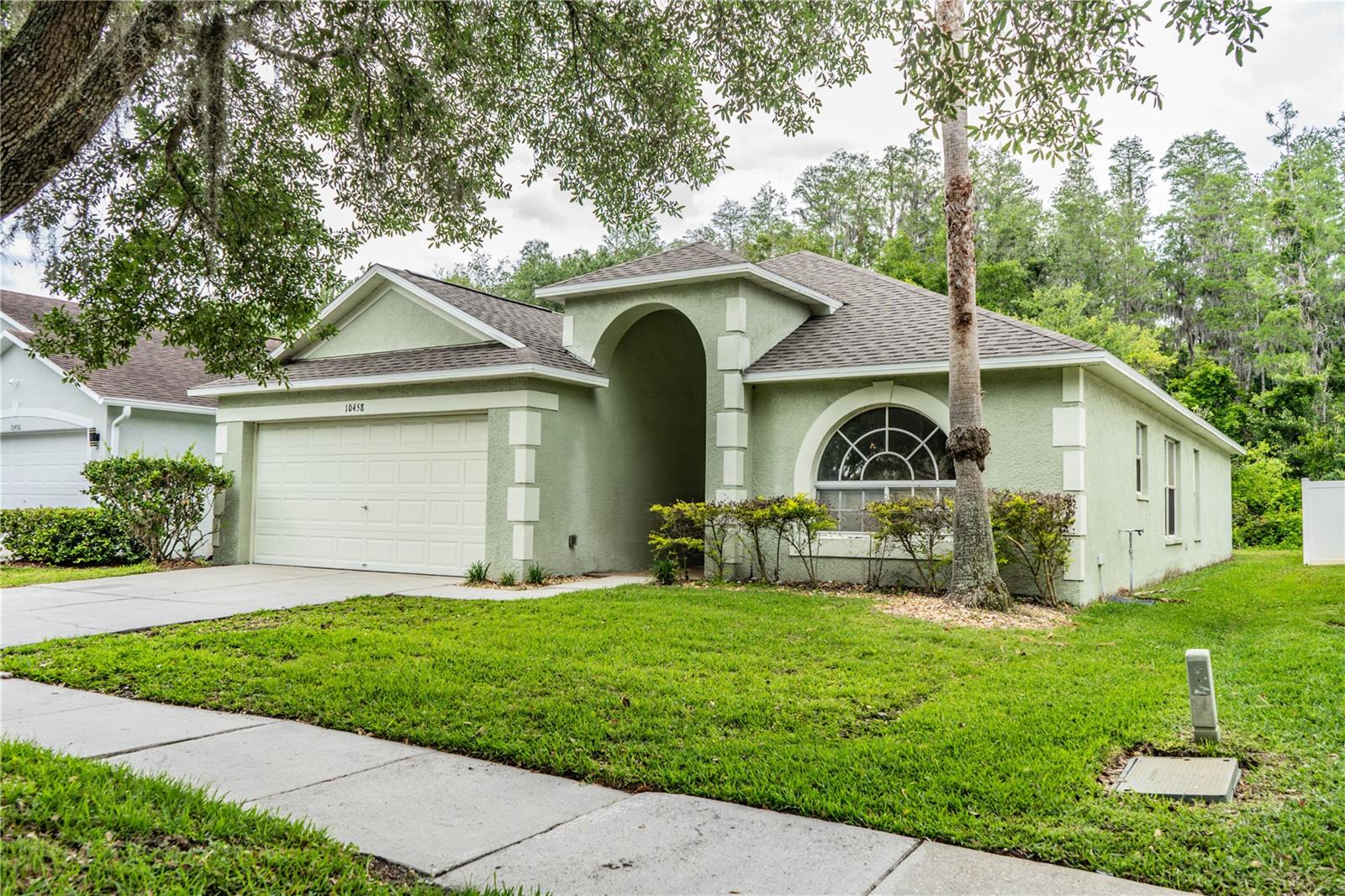 Welcome to this 3-bedroom, 2-bath home offering 1,620 sq ft in the gated Heritage Isles Golf Community of New Tampa. The home features a functional layout, abundant natural light, and fresh interior paint. Major updates include a new roof (Sept 2025), new water heater (Oct 2025), and AC (2022).Enjoy added privacy with no rear neighbors, as the property backs to peaceful wooded views. The home offers a great opportunity to personalize while already having the big-ticket items completed.Heritage Isles is known for its resort-style amenities including an 18-hole championship golf course, clubhouse with restaurant, Olympic lap pool, family pool with waterslide and splash pad, fitness center, tennis, basketball, sand volleyball, and playground. Conveniently located near I-75, top-rated schools, shopping, and dining.