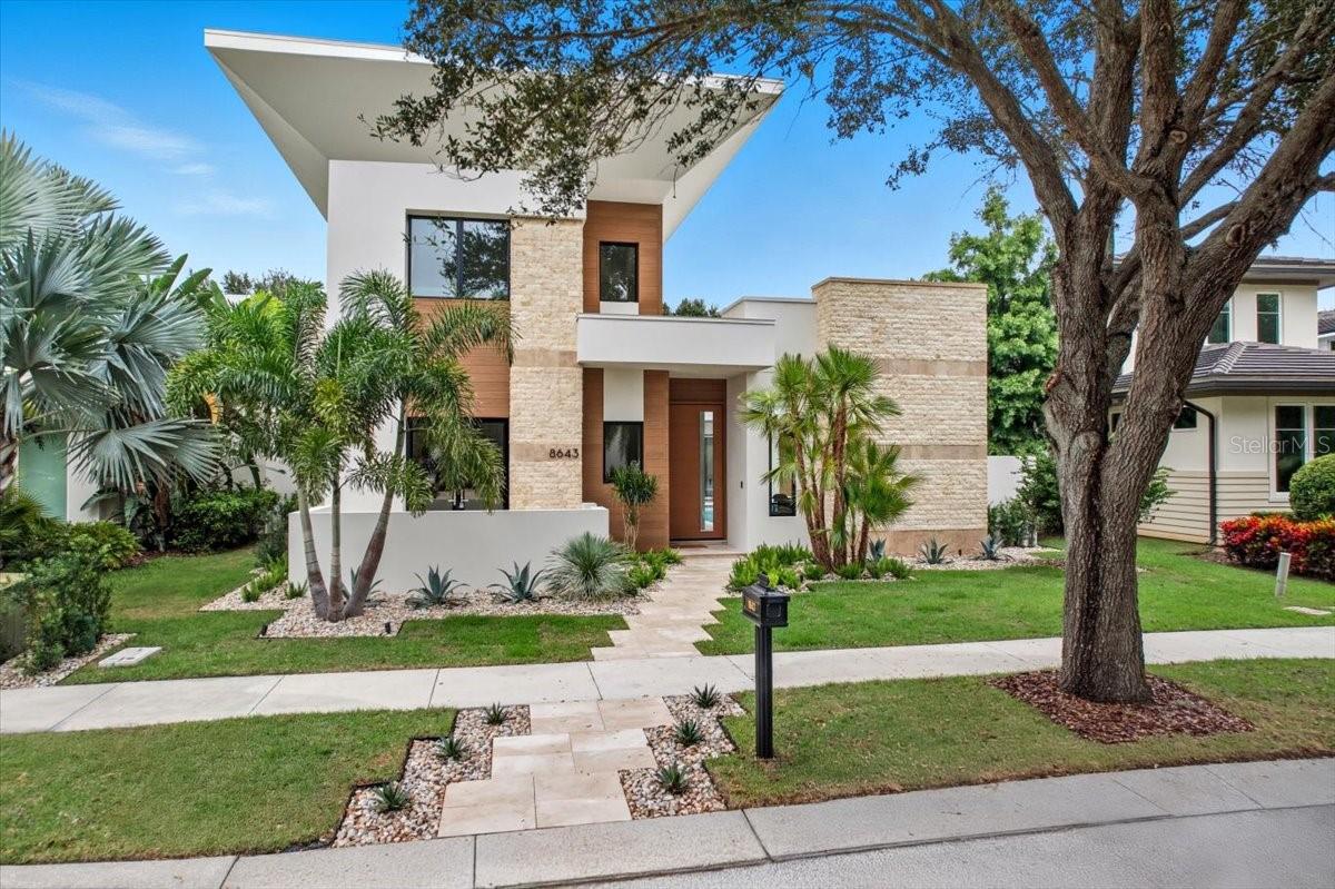 Situated on a lot spanning over a quarter of an acre, this stunning DeVoe Custom Home encompasses just under 5,500 square feet. It features five spacious bedrooms, five lavish bathrooms, and two additional half baths. Designed with both elegance and comfort in mind, this home showcases modern luxury seamlessly paired with timeless design elements.

Step into an open-concept living space, where soaring ceilings—exceeding 22 feet—combine with expansive windows to flood the home with natural light. The gourmet kitchen is equipped with top-of-the-line appliances, custom cabinetry, and a unique double kitchen island, making it the ideal space for entertaining and culinary creativity. Adjacent dining and living areas flow seamlessly, enhanced by bespoke finishes, a gas fireplace, and panoramic views of the manicured grounds.

The primary suite is a private sanctuary, featuring a spa-like bathroom with a soaking tub, dual vanities, a walk-in rain shower, and an immense, custom-designed closet. Each additional bedroom includes an en-suite bathroom and walk-in closet, ensuring both comfort and privacy for family members or guests.

Outside, the custom-designed spa and pool area provide the ultimate in relaxation, complete with a privacy wall for added seclusion. The landscaped yard offers ample space for outdoor gatherings, whether lounging poolside or dining al fresco on the covered patio.

Additional luxury features include a floating illuminated staircase with glass handrails, a temperature-controlled wine enclosure/display, and both upstairs and downstairs laundry rooms—each equipped with washer and dryer units. A dedicated utility storage room offers over 120 square feet of air-conditioned space, ensuring plenty of additional storage.

This home is perfect for hosting or enjoying peaceful, everyday luxury. Custom lighting and fixtures, a spacious three-car garage with dedicated space for golf cart parking, and a versatile office/flex space for work or hobbies round out the exceptional offerings.

Located in the heart of Lake Nona Golf & Country Club, this luxury estate provides unparalleled access to local amenities, fine dining, and top-rated schools. Floor plans are available upon request.