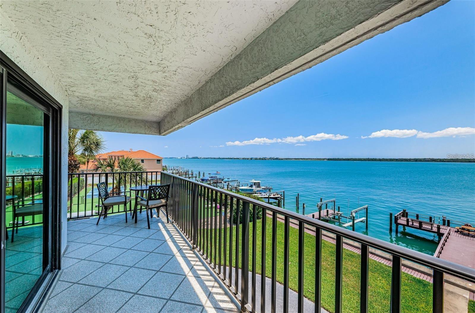 Live Where the Dolphins - Step into a one-of-a-kind waterfront lifestyle in this stunning 2-bedroom, 2-bathroom condo on Sand Key, where every day begins with a breathtaking sunrise over Clearwater Bay and ends with a sunset stroll just across the street on one of Florida’s most beautiful beaches. Perched on the third level, this condo delivers an unforgettable 270-degree panorama from its two wraparound balconies, stretching from bridge to bridge across the shimmering Intracoastal. It’s not just a view — it’s a daily nature show. Dolphins are frequent visitors right in front of the building (so much so that dolphin tour boats often pass by), and birdwatchers will delight in the up-close sightings from this unique vantage point. Inside, enjoy 1,530 sq/ft of light-filled living space with water views from nearly every room. The spacious eat-in kitchen features quality cabinetry, stone countertops, and luxury appliances. The primary suite includes a generous walk-in closet and a beautifully appointed bathroom with dual vanities and a walk-in shower. There’s also a full-size laundry room with extra storage, assigned covered parking, and a dedicated storage unit. But what truly sets this condo apart is not just the location — it’s the lifestyle. The building is part of a well-managed, financially sound community with an active board that maintains the property with pride and care. Amenities include a waterfront pool, pickleball, a fishing pier, grilling area, and the comfort of a gated community. Two small pets are welcome, because even your four-legged friends deserve a little paradise. Whether you're sipping your morning coffee while dolphins dance below or heading out for a sunset cruise from your private dock, this is more than just a home — it’s a front-row seat to Florida coastal living at its finest. Condo management: Harborage II has one of the most active boards with very good residence participation.