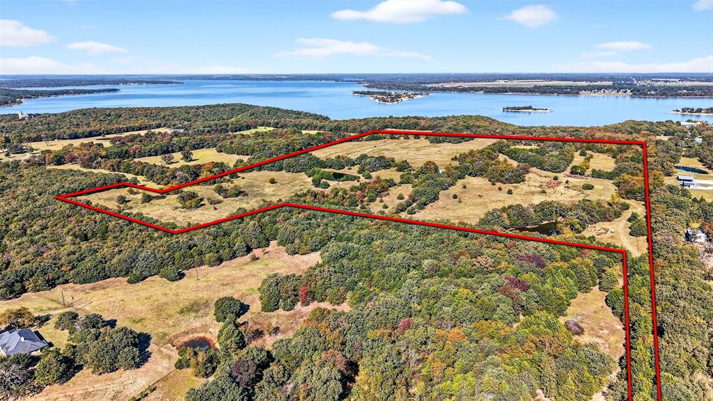 72.75 Acres of Lakefront Opportunity on Lake TexomaDiscover a rare chance to own 72.75+- acres of prime lakefront land on the shores of Lake Texoma, perfectly positioned adjacent to Corps of Engineers property with direct lake access by walking down to the beach. This exceptional tract combines wide-open potential with unparalleled natural beauty, making it ideal for farming, ranching, hunting, fishing, or creating your dream lake retreat.Gently rolling terrain, panoramic water views, and vistas overlooking the lake’s iconic islands create an unbeatable backdrop for anything you envision. Whether you want to build a private getaway, develop a recreational haven, or operate a working ranch, this land offers true do-it-all versatility.Opportunities like this are rare—experience freedom, privacy, and the best of lake life all in one extraordinary property on Lake Texoma.