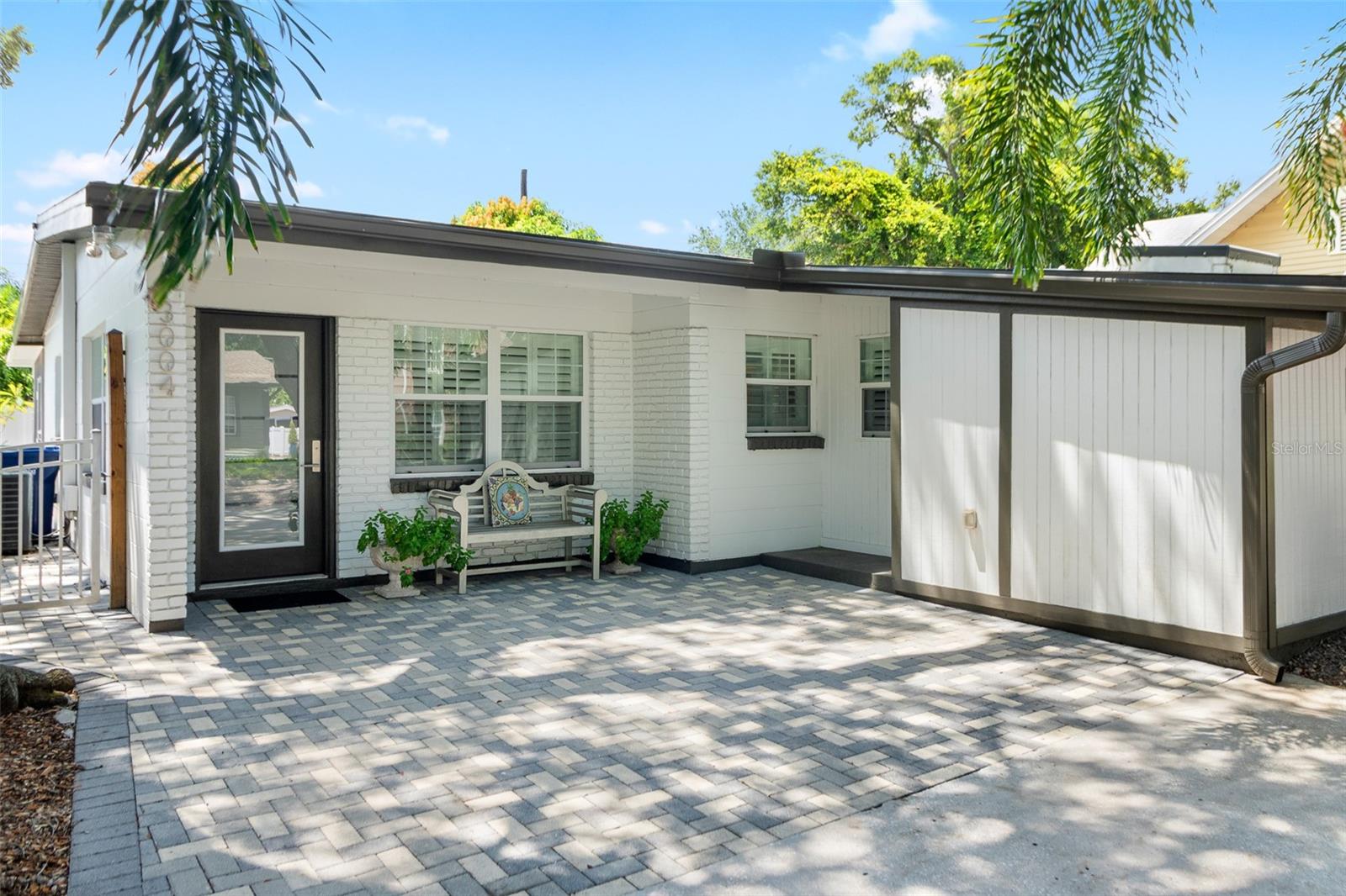 Welcome to Bayshore Beautiful, just 10 homes from iconic Bayshore Boulevard! This charming mid-century home offers an incredible opportunity to live in one of South Tampa’s most desirable neighborhoods, with 3 bedrooms, 2 bathrooms, 1,252 sq ft of living space, and a spacious 50 x 105 lot. Located in the highly sought-after Plant High School district and Flood Zone X, this home combines an exceptional location with classic South Tampa character.Step inside to a bright, open floor plan featuring beautiful polished terrazzo floors, abundant natural light, and a seamless flow between the living, dining, and kitchen spaces. The updated kitchen is designed for both everyday living and entertaining, with granite countertops, wood cabinetry with soft-close drawers, stainless steel appliances, KitchenAid refrigerator, and natural gas cooking.The home also features energy-efficient double-pane windows and sliding glass doors, plantation shutters, a tankless water heater, and a beautifully renovated primary bedroom and bathroom.One of the standout features is the expansive 494 sq ft screened-in lanai, creating nearly 500 additional square feet of covered outdoor living space. Perfect for entertaining, dining, or simply enjoying the Florida lifestyle year-round. Beyond the lanai, the fully fenced backyard features low-maintenance landscaping, mature shade trees, and producing mango trees.The newly paved walkway and oversized driveway provide plenty of off-street parking, while the block utility shed offers additional storage.And the location is hard to beat. Enjoy morning walks or evening bike rides along Bayshore Boulevard, with Hyde Park, Downtown Tampa, local restaurants, boutiques, coffee shops, and everything South Tampa has to offer just minutes away.