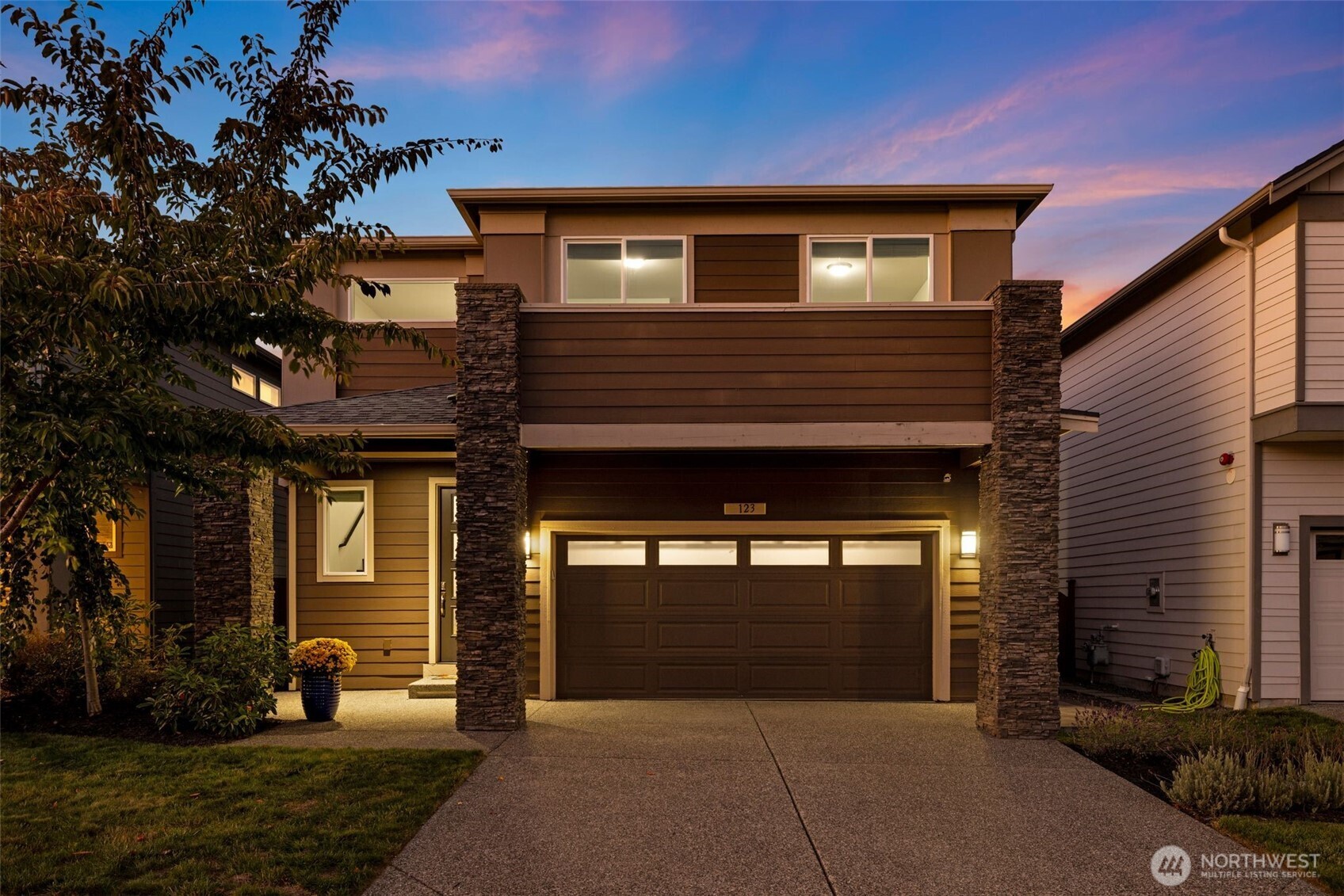 Built in 2018, this contemporary Ryan Park home welcomes you with radiant natural light and rich espresso-toned hardwoods that sweep across the open main floor. A sleek kitchen with quartz countertops, full-height tile backsplash, and pantry flows effortlessly into the dining area and fenced backyard—an inviting setting for al fresco entertaining. The living room’s stacked-stone fireplace forms a warm centerpiece, while upstairs, a spacious bonus room and tranquil primary suite offer everyday retreat. With over $65K in upgrades, the home showcases expanded hardwoods, backyard hardscaping, and an upgraded garage with epoxy floors and custom storage. Just steps from a community park and within the sought-after Northshore School District.