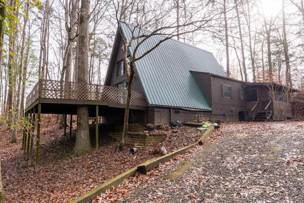 Affordable cozy A-frame home just 15 minutes from Downtown Murphy! This 2BR/2BA property with a loft sits on just under a half acre and offers unlimited potential. With a little TLC, this home can easily be transformed into a charming mountain getaway or full-time residence. Enjoy the freedom of unrestricted land, plus a handy shed/outbuilding for storage or workshop use. Inside, you'll find an open layout with warm natural light, a comfortable living area, and a versatile loft space perfect for an office, bonus sleeping area, or hobby room. Outside, the gently-sloping yard provides room to garden, relax, or expand. If you're looking for a property you can personalize in a convenient location close to Murphy's shops, dining, and outdoor recreation—this is the one!