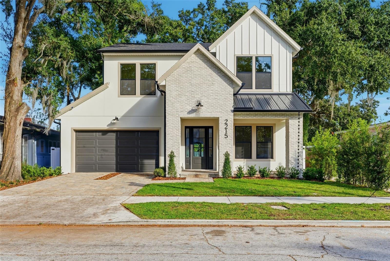 Meticulously designed by Fortis Enterprises, this custom 4BD/3.5BA residence with an office and a first-floor primary suite is nestled in the heart of highly desirable College Park. Step inside to find 10-foot ceilings on both levels, rich hardwood flooring, solid-core doors, and a welcoming front porch accented with pavers, a metal roof, and a tongue-and-groove ceiling. The gourmet kitchen is a showpiece, featuring quartz countertops, solid wood soft-close cabinetry, under-cabinet LED lighting, a spacious island, walk-in pantry, and premium Thermador appliances. A separate dining area, bathed in natural light, creates the perfect space for gatherings. The primary suite is a private retreat with a spa-like bath offering dual vanities with quartz counters, a soaking tub, a frameless glass shower, and direct access to an oversized laundry room and generous closets. Upstairs, three bedrooms include one with a private en suite and two that share a dual-vanity bath, along with a large bonus room ideal for work, play, or relaxation. Enjoy indoor-outdoor living on the oversized lanai with its newly built summer kitchen and stained tongue-and-groove ceiling. Additional highlights include: unfinished attic storage, a high-efficiency HVAC system, tankless water heater, termite bond, and builder warranties (1-year workmanship, 10-year structural). The Sherwin-Williams exterior paint system is backed by a 10-year warranty. Schedule your private tour today and experience this home for yourself!