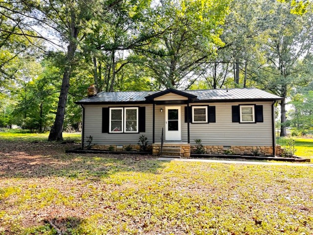 DON'T MISS OUT ON THIS GREAT STARTER HOME!! New metal roof, new HVAC, new LVP floors, new cabinets, countertops, SS appliances, doors, gutters, and all new fixtures. This move-in ready gem sits on an expansive corner lot with plenty of room to grow.  The bright open layout offers comfortable living space with great natural light throughout. Kitchen features a spacious pantry. Outside you will find a storage building that remains as well.  Selling AS IS!