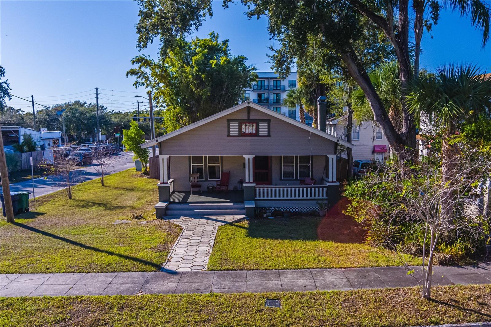 A Rare Seminole Heights Bungalow Restored with Care, Crafted to Last! Built by hand and rich with history, this exceptional bungalow is a contributing historic home in the Old Seminole Heights Local and National Historic District. Lovingly owned and restored since 1997, it showcases the enduring beauty of original craftsmanship paired with thoughtful modern upgrades.From the original longleaf heart pine tongue-and-groove floors to beautifully preserved plaster walls, this home tells a story of quality construction rarely found today. The heart of the home is the expansive great room, where a restored historic fireplace anchors the living space and flows seamlessly into the dining area, complete with a built-in serving pantry and an original, room-length window seat.The fireplace itself was professionally rebuilt by one of Tampa’s top licensed masons, featuring a new firebox, foundation, modern flue, and chimney cap—ensuring safe enjoyment for generations to come. A charming historical detail remains: handprints dated January 7, 1941, preserved in the exterior plaster.The oversized original bathroom is a standout, featuring porcelain hex tile floors, a clawfoot tub, historic sink, medicine cabinet, and a rare 1920s dentist cabinet. Thoughtful restoration includes nickel-replated original hardware, blending authenticity with longevity.Both bedrooms have been fully restored, including a spacious primary bedroom and a second bedroom with an adjoining bath, ideal as a guest room, nursery, or home office. Throughout the home, you’ll find exceptional historic details: picture rails, original wood doors and hardware, custom window trim, and fully reconditioned original windows with period-appropriate wood screens and copper mesh.The 280-square-foot front porch has undergone a historically accurate restoration, including original tongue-and-groove flooring - perfect for relaxing and enjoying the neighborhood.The kitchen and laundry renovation (2017) was a full rebuild designed to honor the home’s era while delivering modern functionality. Highlights include a fully restored 1929 Magic Chef gas range, a 1926 American Standard sink with built-in sideboard, custom solid wood cabinetry, Bosch dishwasher with custom panel, and age-appropriate lighting from Rejuvenation. The rebuilt laundry room features stacked washer/dryer, stainless utility sink, custom counters, preserved original chimney, and a charming breakfast nook with French doors leading to the backyard. Major system upgrades include:New Galvalume standing-seam metal roof with extensive wood decking replacement.  Updated electrical system with modern Romex and expanded panelReplaced sewer line to city tap (4" PVC with cleanouts)HVAC system replaced in 2022, plus new mini-split in back roomRestored natural gas service and new gas water heaterNew refrigerator (2024), stacked washer/dryer (2024), and backyard wood fence (2024)A truly special opportunity to own a historically significant home in one of Tampa’s most vibrant neighborhoods, where character, community, and craftsmanship meet.