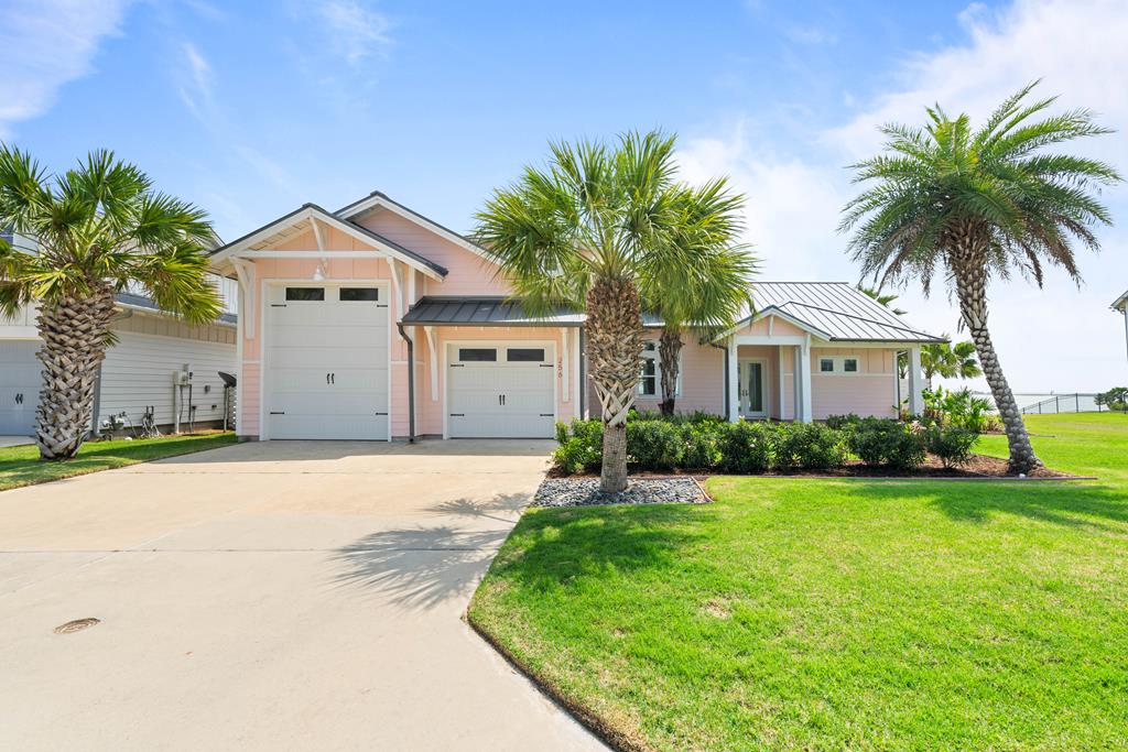 WATERFRONT HOUSE & ADDITIONAL LOT NEXT DOOR: Experience elevated coastal living in this beautifully designed 4-bedroom, 3-bath home located on the bay front in the prestigious Reserve at St. Charles Bay. This spacious property offers unmatched water views, lush tropical landscaping, and a seamless blend of indoor and outdoor living. Inside, enjoy an open-concept layout filled with natural light, ideal for both entertaining and everyday relaxation. The primary suite features a spa-like bath with a master shower that opens to a private outdoor shower—perfect for rinsing off under the stars. The upstairs bonus room provides flexible space—perfect for a home office, gym, or guest overflow. The oversized 2-car garage includes a 12-ft high door, ideal for storing your boat and coastal toys. Step outside to take in the sunrise from your patio or enjoy the breeze off the bay in this quiet, gated community known for its resort-style amenities. Bonus: This sale includes the adjoining lot at 260 Reserve Lane, offering added privacy, room for expansion, or the ultimate backyard oasis. A rare opportunity to own two bayfront properties in one of Rockport's most sought-after waterfront neighborhoods.