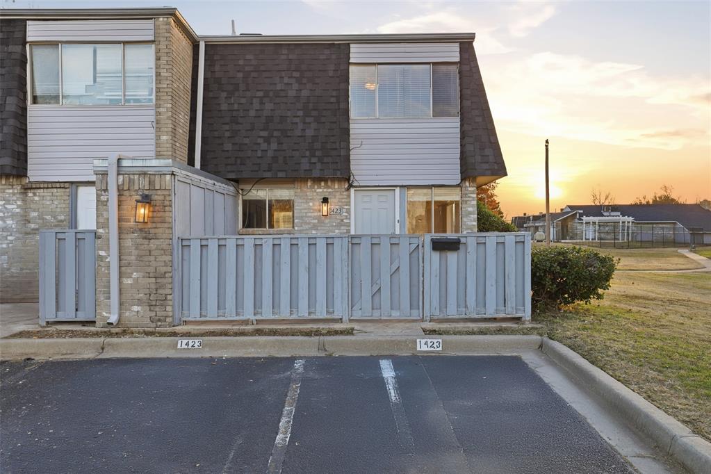 Welcome to a cozy 1,200 sq ft townhouse that invites you to live with ease and comfort from the moment you step inside. Crisp white tile in the kitchen and dining area keeps the space bright, clean, and easy to maintain, perfect for weeknight dinners, relaxed weekend mornings, or hosting friends before the big game. Just beyond the dining room, a fenced patio offers a quiet spot for coffee, plants, or extra storage, with two outdoor closets ready to keep things organized.All three bedrooms are tucked upstairs together, giving the home a natural sense of privacy. The two full bathrooms make busy mornings simpler, while the freshly painted kitchen cabinets add a bright, updated touch to the heart of the home. Being just steps from the community pool means summer days can feel like a getaway after cheering on the Sooners. Best of all, this location is a game-day dream, only 9 minutes from Gaylord Family - Oklahoma Memorial Stadium, making it easy to head out for kickoff and just as easy to return home after the win.Practical perks include two assigned parking spaces, plus the fridge and washer/dryer already in place for the new owner. HOA dues remain a low $220/month and cover the roof, exterior maintenance, insurance, and access to the pool, offering both convenience and peace of mind.A home designed for cozy living, effortless hosting, and enjoying every season, football included.