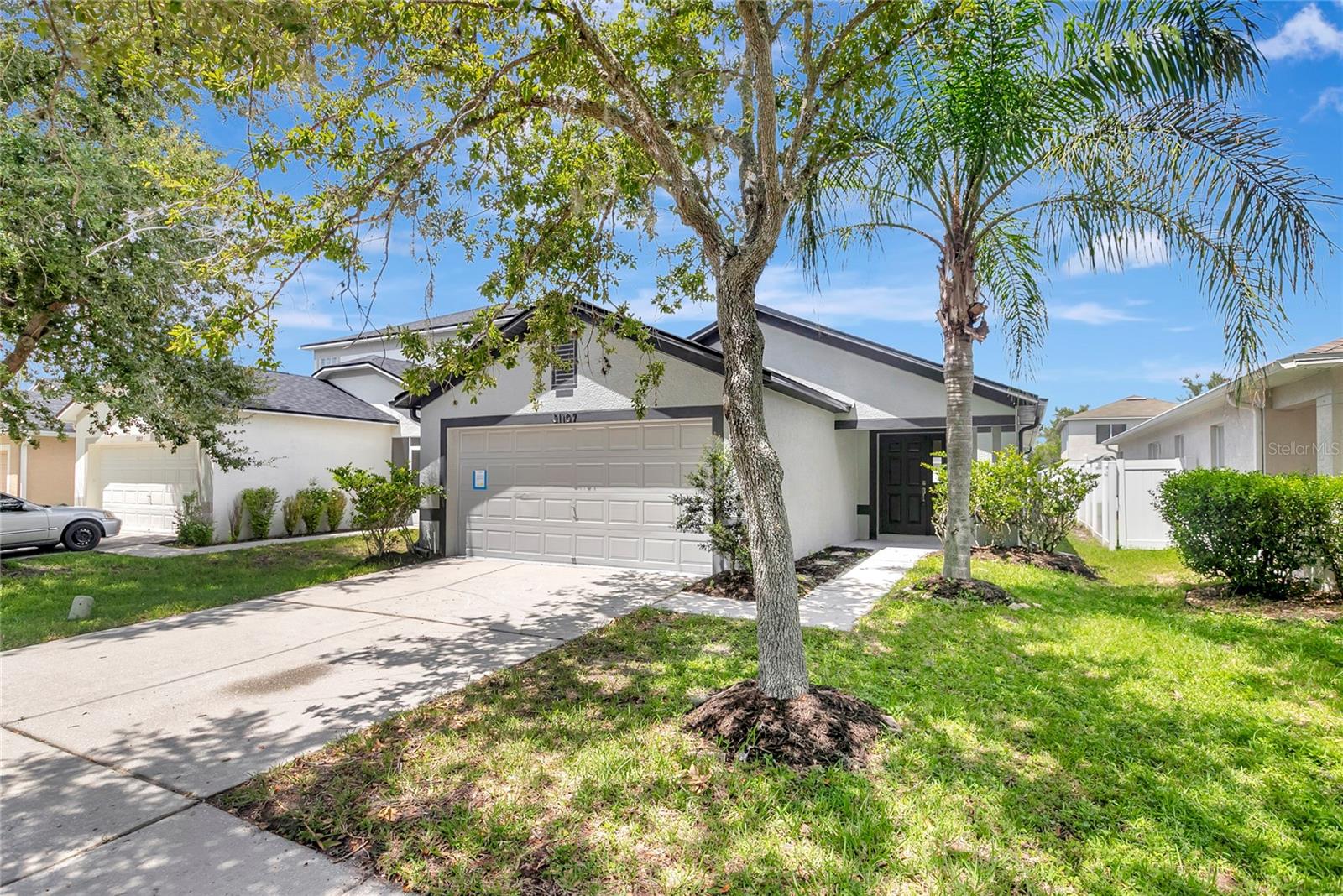 TASTEFULLY RENOVATED 3 BEDROOM 2 BATH HOME located in Wesley Chapel's Bridgewater Subdivision. LOW HOA. NO FLOOD ZONE. NEW ROOF! NEW AC! Upon entering the home, bright and airy with lots of natural light coming through. Freshly painted inside and out. Updated lighting and plumbing fixtures. The cook in your home will appreciate the brand new kitchen featuring all new wood cabinets, quartz countertops and Stainless Steel appliance package. Bathrooms have been fully updated with new vanities, updated lighting and plumbing fixtures. Open floor plan for lots of entertaining. Sliding doors leading out to screened Lanai. Large backyard for social events. Spacious 2-car garage with lots of room for storage. Home is conveniently located to shopping and restaurants. Make this home yours today!!