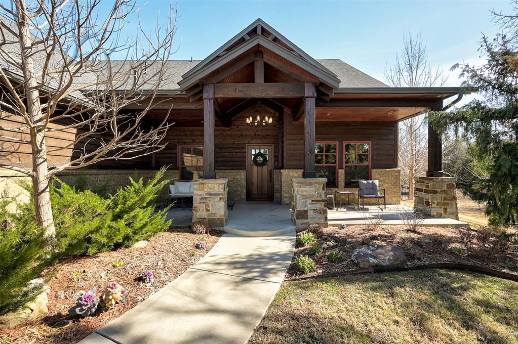 Welcome to this private retreat in the desired community of Cottage Grove, where custom craftsmanship & elevated design come together in perfect harmony. From the moment you enter this home, the richly stained wood accents & thoughtfully curated finishes set the tone for a home that is both warm & refined. The spacious living room features a beautiful stone fireplace with accent wood that carries your eyes up to the ceiling, where bold exposed beams create a striking architectural centerpiece. The kitchen has stunning custom cabinetry, a statement black hutch with purposeful storage, double islands with contrasting butcher block & a solid slab of beautiful granite that is both eye-catching & functional. The glass backsplash with pot-filler adds a great chef's touch for cooking on your Wolf Range. A private downstairs study with elegant French doors offers the perfect work-from-home retreat. The stunning primary suite is a true sanctuary, complete with a spa-like bathroom featuring a walk-in shower with river stone tile, his-and-hers vanities, and a luxurious soaker tub. & natural light filtered through classic plantation shutters. This home offers four additional secondary bedrooms with spacious closet space and plenty of room for family members or guests. Upstairs is a spacious bonus room, making it a great flex space for anyone's needs, two secondary bedrooms & a full bathroom, making it convenient for all. Throughout the home, the lighting design is as intentional as it is beautiful--from the statement pendant lights to designer ceiling fans, every detail speaks to elevated taste. This home backs up to a wooded greenbelt with captivating forest views, a private oasis. Enjoy the view from either your covered patio or the extended Trex deck built to support a swim spa/hot tub. An attached insulated shed, storm shelter, and fire pit are an added bonus. This home is perfect for entertaining family & friends, stargazing, gardening & nature lovers, make it yours today!