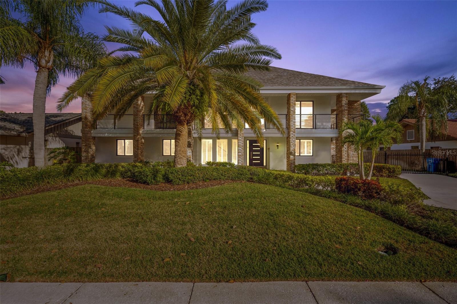 Welcome to an extensively renovated waterfront estate in Sweetwater, one of Tampa’s premier private, gated communities. Positioned on a protected deep-water canal with direct access to Tampa Bay, this exceptional 5-bedroom, 4-bath residence combines spacious living, resort-style amenities, and an outstanding setup for boaters.Since its previous sale, the home has undergone a comprehensive transformation. The kitchen has been completely remodeled, all four bathrooms have been renovated, and new flooring has been installed throughout the lower level. The reconfigured living room, remodeled in 2023, now features a custom minibar and an improved layout for entertaining. Additional upgrades include a new HVAC system installed in 2024, a new electrical panel installed in 2025, a replaced garage door, and fresh exterior paint.The grand foyer and soaring ceilings introduce a bright, expansive floor plan. At the center of the home is the newly remodeled kitchen, offering generous cabinetry, extensive counter space, oversized seating areas, dual ovens, and an effortless connection to the main living and dining spaces. A first-floor bedroom and full bathroom provide flexibility for guests or multigenerational living. The home also includes a bonus room currently configured as a fully equipped home gym.Upstairs are four additional bedrooms, including the primary suite, a junior suite, and two guest bedrooms connected by a Jack-and-Jill bathroom. The luxurious primary suite overlooks the water and includes a private covered balcony, an expansive custom-organized walk-in closet, and a fully remodeled spa-inspired bathroom completed in 2023. The bathroom features a deep soaking tub, oversized shower, and separate vanity areas.Situated on one of the largest lots in the community, the backyard has been designed as a private waterfront resort. The pool, constructed in 2022, features wireless controls, a sun shelf, waterfall and fountain features, color-changing LED lighting, bubbling seating, and swim-out shelves. An above-ground hot tub, tropical landscaping, expansive decking, covered outdoor living areas, and an outdoor kitchen installed in 2023 create the perfect setting for relaxing or entertaining year-round.For boating enthusiasts, the property offers an oversized dock and two boat lifts rated at 13,000 and 10,000 pounds. With approximately 6–7 feet of water at low tide, the canal can accommodate larger boats while providing protected access to the open waters of Tampa Bay. Dolphins, manatees, and abundant fishing opportunities complete the waterfront experience.The rear-entry garage is accessed through a private pull-around driveway with an electronic gate, providing secure parking and an enclosed outdoor area for pets. Two levels of covered porches add to the home’s distinctive Florida architecture and provide multiple vantage points for enjoying the waterfront setting.Located just minutes from Berkeley Preparatory School, Tampa International Airport, International Plaza, downtown Tampa, and some of the area’s best dining and shopping, this turnkey residence delivers the space, privacy, boating access, and resort-style lifestyle that define exceptional waterfront living in Tampa Bay.