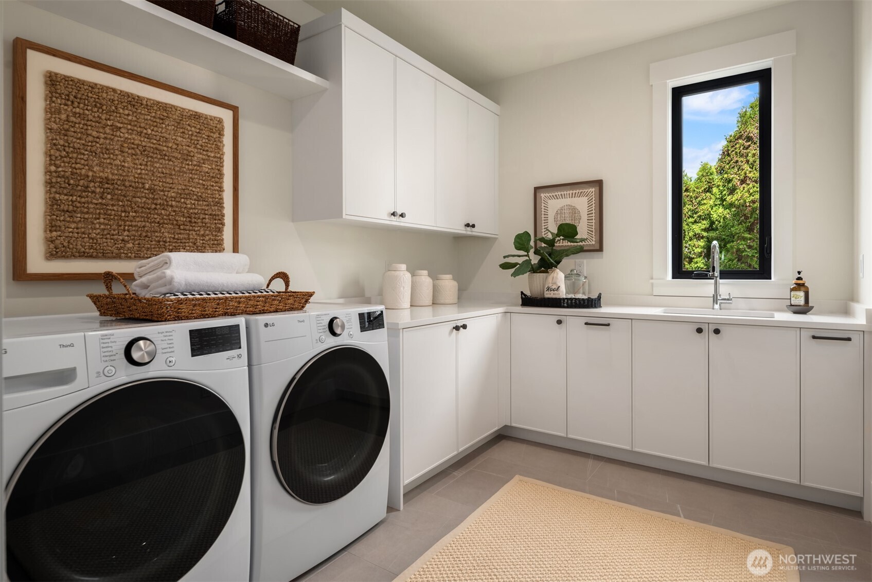 Laundry room with white cabinentry and utility sink
