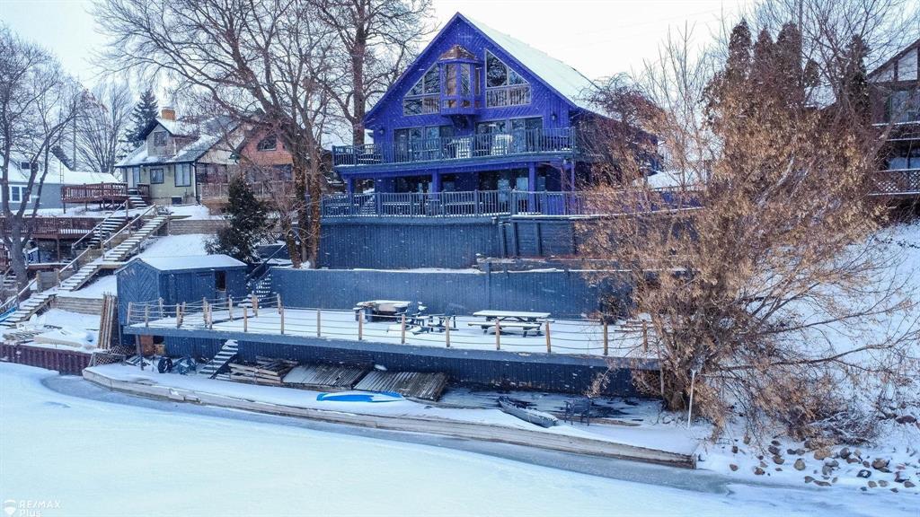 Wake up to breathtaking views of Lake Nepessing-an all-sports lake where every day feels like a vacation. With summer just around the corner, now is the perfect time to secure your slice of lakefront paradise. Whether you love boating, swimming, fishing, or simply embracing the lake lifestyle year-round, this property delivers it all. Nestled in desirable Elba Township, this stunning home offers 63+ feet of private lake frontage and convenient access to Interstate 69, along with nearby restaurants, shopping, and golf courses-combining peaceful waterfront living with everyday convenience.  Originally built in 1990 and recently renovated with a modern twist, this exceptional home features fully equipped upper and lower living quarters-ideal for multi-generational living, extended stays, or hosting guests in comfort and style. Designed for both relaxation and entertaining, the expansive two-story deck showcases spectacular sunset views over the water. Inside, the light-filled great room impresses with soaring ceilings and an open, airy design that maximizes natural light and lake views. The versatile loft offers endless possibilities-perfect as a primary suite, home office, or playroom-and includes access to a wraparound interior balcony overlooking the main living space. Spacious bedrooms provide comfort and privacy, with three featuring their own private full baths. This one-of-a-kind lakefront retreat truly must be seen to be fully appreciated.