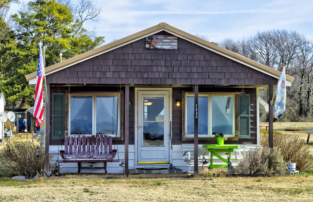 This charming beach cottage nestled on the beautiful Chesapeake Bay has so much to offer!  VIEWS! VIEWS! VIEWS!  The MOST amazing sunsets you've ever seen right from your very own front porch!! The peace and tranquility you find here is like no other.  Spend your days fishing or crabbing from the pier, launch a kayak or plant your toes in the sand down at the private community beach then enjoy an outdoor shower to clean off the salt and sand! Complete with a shed for all your storage needs and a screened in porch to enjoy your catch of the day! This cottage has been well maintained with recent upgrades including an instant hot water heater, new metal roof and new floors!!  The memories that can be made here are endless!!!!!
