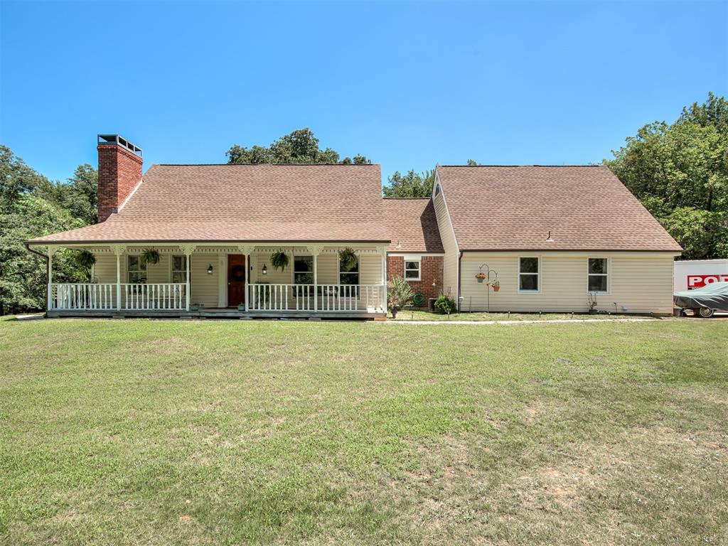 This beautiful home has so much CHARM!! Nestled amongst the trees on 2.45 acres, with a playhouse & nature trails to explore. The home features a huge front porch perfect to watch the sunset from your front porch swing. Master Suite on the first level has an attached sun room, just delightful for sipping your morning coffee. Also, on the first level is a Junior Suite with a kitchenette & full bathroom & laundry. Kitchen has beautiful brick flooring & bricked around stove area. Upstairs, you'll venture into 3 more bedrooms, 2 full bathrooms & a bonus room...just enough space for lounging & entertaining. New deck out back. Storage container w/ playhouse & small storage building in backyard. Roof replaced 2020, HVAC replaced in 2023 & Well pump replaced in December 2025. Brand new microwave. A majority of paint & flooring have been updated recently. Fridge in kitchen, washer & dryer, and tractor w/ attachments can stay w/ acceptable offer. Additional laundry hookups are located behind mud bench between kitchen & Junior Suite.