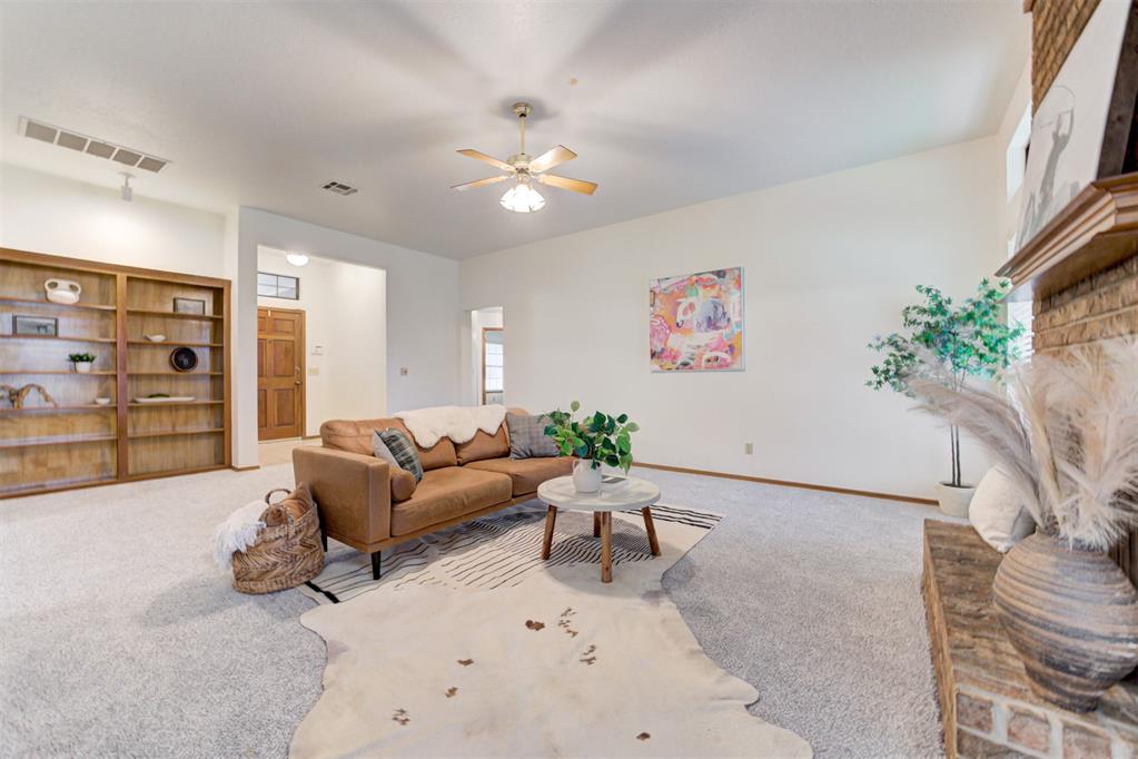 This beautifully maintained home is nestled on a desirable corner lot, features a simple yet inviting landscape. 
Step inside to a bright and airy living room filled with natural light, warm neutral tones that compliment the rich, stained wood accents, centered around a cozy fireplace. Off the living room, you’ll notice the dining area, laundry room, and a spacious kitchen equipped with a breakfast bar, ample cabinetry, generous counter space, and a breakfast nook that overlooks the backyard.
The primary suite offers an en-suite bathroom featuring double sinks, a soaking tub, separate shower, and a wraparound walk-in closet with abundant storage; additionally two secondary bedrooms, a guest bath, and a linen closet are all situated on one side of the home.
Enjoy the outdoors in the backyard, complete with a covered porch and plenty of space for gardening or entertaining. Additional highlights include an in-ground storm shelter in the garage, in-ground sprinkler system, and close proximity to the neighborhood playground and pool.
This home blends comfort, functionality, and community in a highly desirable location.