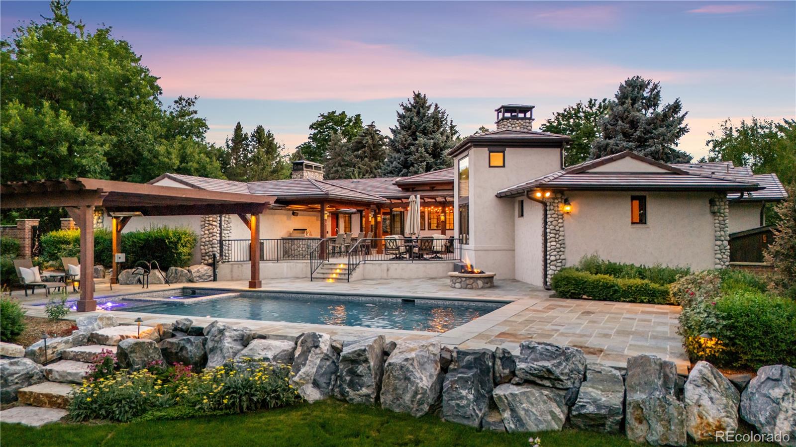 Welcome to 2305 Cherryville Road, a completely reimagined home sitting on one of the most stunning lots in the metro area.This home has undergone extensive renovation, including the construction of a great room with 13-foot vaulted tongue and groove ceilings, fully remodeled kitchen anchored by a Wolf range, Sub-Zero refrigerator, and elegant granite countertops. But the best part may be the spectacular, million-dollar backyard that you need to see to believe; a resort-like pool/hot tub area, full multi-level patio with outdoor kitchen, and meticulous landscaping that includes fruit trees, two water features, seemingly endless flower beds, and complete and total privacy.The great room and open kitchen flow seamlessly to the outdoor living spaces—where French doors open to an entertainer’s paradise. Adjacent to the kitchen are the formal dining area and a cozy den with a gas fireplace, offering the ideal layout for both intimate evenings and larger gatherings.The home features four spacious bedrooms and four baths, along with a dedicated home office designed for privacy and inspiration. The primary suite is a standout, with hardwood floors, fireplace, a custom-built walk-in closet, and a spa-inspired bath. An adjoining office space overlooks the lush backyard and pool, while more French doors provide direct access to the patio,creating a private retreat within your own home.The finished lower level adds flexibility and space, featuring a generous family room and a versatile bonus area perfect for a media room, home gym, or game room.Outside, the grounds are nothing short of exceptional. Mature trees provide shade and seclusion and tranquil water features complement the picturesque pool and patio. It’s a backyard sanctuary designed for both relaxation and entertaining—beautifully private, yet effortlessly grand.Minutes from the Highline Canal Trail and shopping. 2305 Cherryville Road offers the kind of living that simply can’t be replicated.