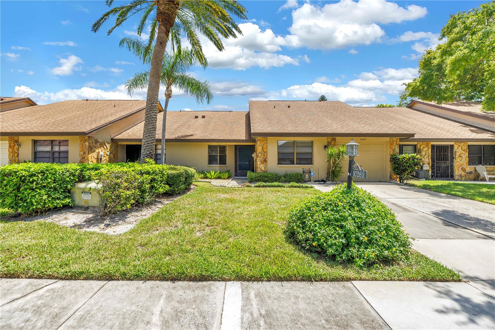 SPACIOUS 2 bedroom, 2 bath villa in Lake Seminole Village! Gorgeous open floor plan and soaring vaulted ceilings accentuates how light and bright this villa is. The home cook is sure to appreciate the generous kitchen with it’s cheerful breakfast nook and abundance of real wood cabinets. Plenty of space to entertain with both the expansive living room AND a family room overlooking the fenced backyard. Split floor plan allows for privacy for everyone. The primary bedroom is spacious and can accommodate large furniture, there is also a huge walk in closet. Primary bedroom complete with en-suite bathroom featuring a tiled walk-in shower. Additional bedroom is also generously sized. The guest bathroom is updated with a tub shower combo. Relax with your morning coffee from the comfort of your huge back private patio, or is also a great spot to enjoy a backyard BBQ. Oversized 1 car garage includes plenty of storage space. This home has been lovingly cared for and includes a newer AC (2016), Roof (2016), and Water heater (2021). Located on a peaceful street and just a short stroll from the pool this is a prime location in the neighborhood! Located in a no flood zone! Saves you money and offers peace of mind. Pride of ownership is evident in this community. Lake Seminole Village is a perfectly maintained, deed restricted neighborhood. The association maintains your lawn, exterior painting, irrigation systems, resort style pool, roofs and includes Internet AND cable package. This is an easy living lifestyle conveniently located just minutes from Lake Seminole Park, Seminole City Center & several of Florida’s World Class Beaches.