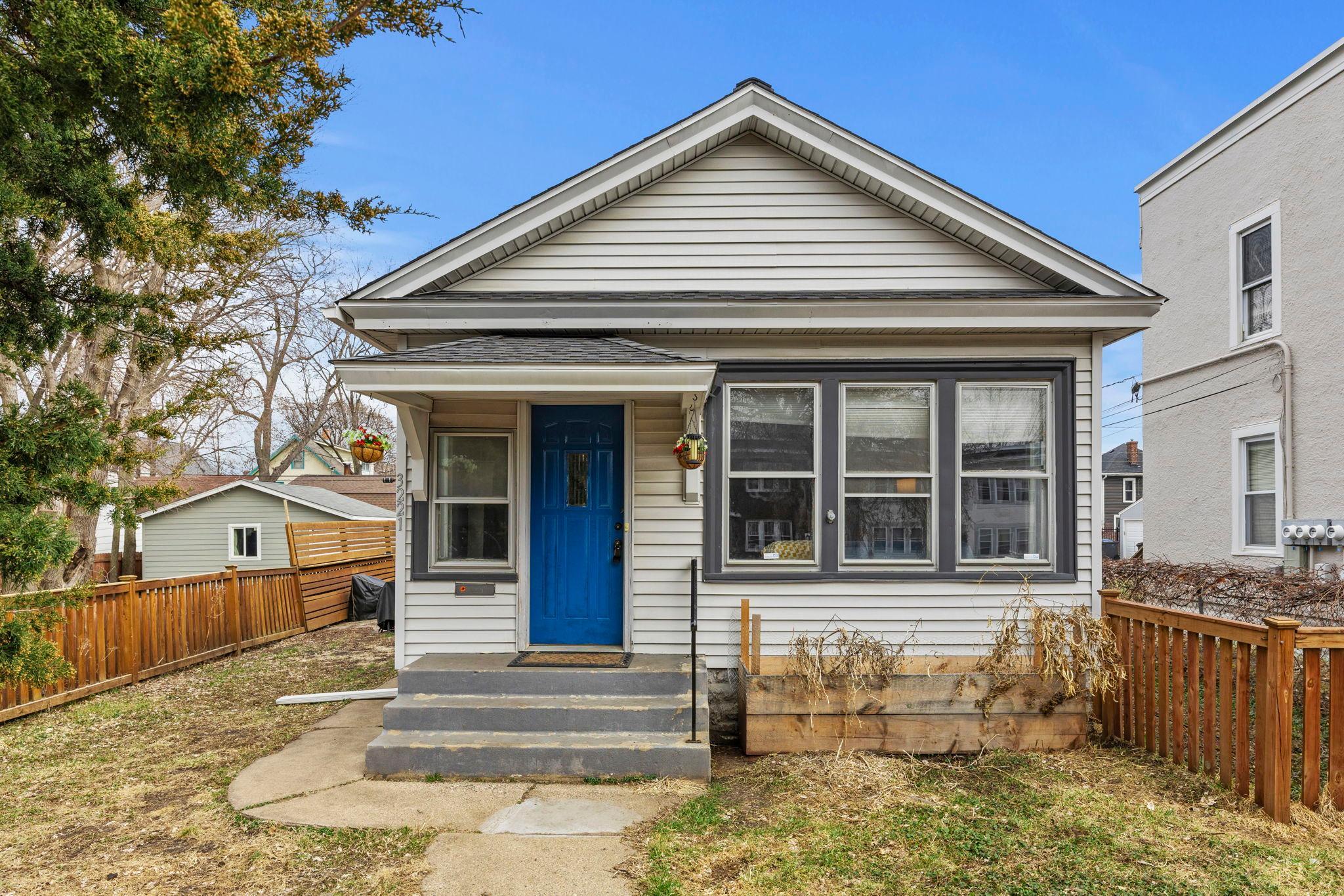 Welcome to this spacious 2-bedroom, 2-bathroom home in Minneapolis, just minutes from Bde Maka Ska, offering easy access to trails, recreation, and lakeside amenities. Located near Uptown’s shopping, dining, and nightlife, this home blends peaceful living with urban convenience in a walkable, bike-friendly setting. A bright foyer opens to the main living areas, where hardwood floors create a warm, cohesive feel. The living room serves as a central gathering space, featuring a decorative fireplace, built-in cabinetry, and grid-style windows that invite natural light. Just off the living room, a sunroom with a wood-paneled accent wall overlooks the fenced front yard, perfect for relaxing, working, or entertaining. The dining room flows seamlessly into the kitchen, offering an ideal layout for daily living and hosting. The kitchen features stainless steel appliances, a gas stove, stylish backsplash, and space for casual dining. The primary bedroom is conveniently located near the main living areas, while a full bathroom with tile surround and a nearby hall closet add functionality. The second bedroom, tucked at the back, offers privacy, built-ins, and access to a nearby half bath.A rear mudroom/laundry area leads to a fenced yard with a paver patio, ideal for outdoor living. A detached two-car garage and ample street parking complete the home.