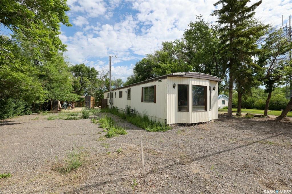 Welcome to 104 Nicoll Ave, If your looking for an affordable beach property, check out the potential 4 season residence offering a comfortable and convenient lifestyle at Regina Beach. Great lot with tons of potential from commercial usage or renovate the existing mobile home or build a new cottage. This home has an open concept livingroom & kitchen area, 3 bedrooms and larger bathroom. It has plenty of parking out front for RV, boats, watercrafts and still room for your vehicles. It also offers a huge decked area with tons of options to create an outdoor oasis, giving plenty of privacy for outdoor activities. This property is situated close to all the amenities making it a perfect location for summer fun. Whether its summer or all year round, Regina Beach offers a variety of amenities and recreational opportunities, Come and experience everything Last Mountain Lake has to offer. Don't miss out on the opportunity to make this space your own. Call your REALTOR or the listing agents for more details!