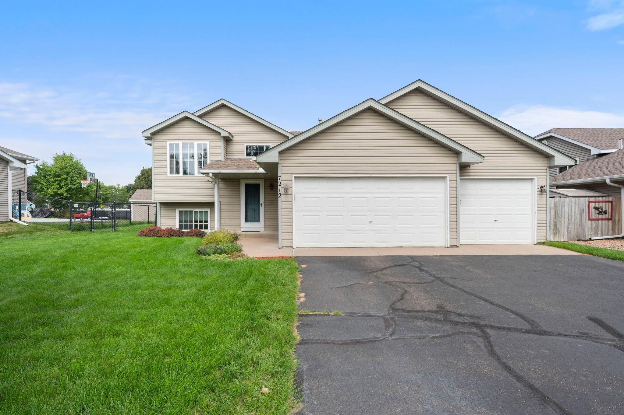 Welcome home to this three bedroom, two bathroom split-level in Cottage Grove, minutes from local shops, dining, entertainment, and a park along the river. The city offers over 1,300 acres of park land, including Cottage Grove Ravine Regional Park, 515 acres with trails for hiking, fishing, and cross-country skiing.The foyer offers access to the attached three car garage with storage in the rafters above the garage and the backyard, along with a spacious closet for storage. Golden oak trim carries through much of the home for a warm, inviting feel.Upstairs, the open living space centers on a cozy bay window overlooking the backyard, with abundant natural light throughout. The kitchen offers a peninsula with seating and a picture window over an informal dining nook. The dining room sits between the living room and kitchen, with sliding glass door access to a spacious deck. The primary suite overlooks the side yard with a walk-in closet, and the second bedroom overlooks the backyard with its own walk-in closet. A full bathroom with linen storage serves this level.A door separates the lower level, offering privacy ideal for a family room, guests, or extra distance from the main living area. The family room has lookout windows to the backyard. The third bedroom includes an egress window and lookout windows, with a 3/4 bathroom serving this level. An unfinished utility and laundry room completes the space with extended storage space under the stairs. The fully fenced backyard includes in-ground irrigation. A neighborhood park is just down the street, with Hamlet Park a short walk further, offering trails, sport courts, ball fields, a skate park, and a playground.