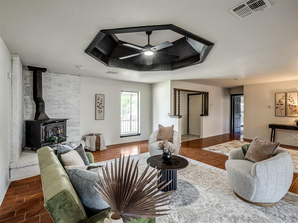 Nearly 2,500 square feet, two living areas, and room for everyone—this beautifully updated corner-lot home offers the space and flexibility today's families are searching for.Inside, you'll find four bedrooms, two full bathrooms, and a layout designed for everyday living. The inviting main living room features warm wood-look tile flooring, striking architectural ceilings, and a wood-burning stove that adds character and charm. The updated kitchen offers new appliances, butcher block countertops, additional cabinetry, and flows seamlessly into both the formal dining room and breakfast area.Just beyond the kitchen and dining spaces, a spacious window-lined bonus room creates the perfect second living room, game room, homeschool area, or home office.The flexible floor plan includes a bedroom and full bath downstairs, while three additional bedrooms upstairs provide privacy and separation. Large closets throughout the home offer exceptional storage, including multiple walk-in closets and dual closets in two of the upstairs bedrooms.Outside, the spacious corner lot provides impressive parking and storage with an oversized driveway, a large three-car carport, two storage buildings, and an above-ground storm shelter. Recent improvements throughout the home include updated flooring, paint, lighting, bathrooms, trim, doors, and exterior siding.Located within walking distance of Moore High School and situated in an established neighborhood, this home offers the rare combination of character, functionality, and the space to truly spread out.