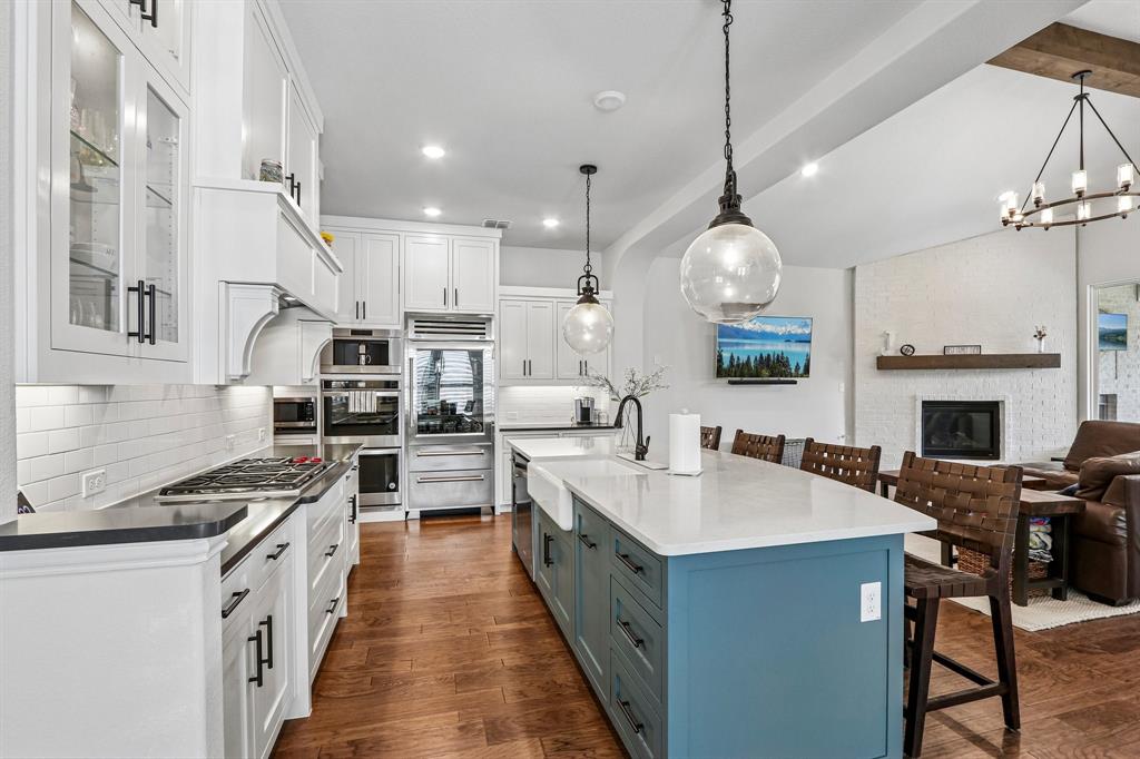 Step into a thoughtfully designed 5-bedroom, 4-bathroom home offering 3,635 square feet of functional living space in the highly sought-after Light Farms community. This multi-story residence stands out with builder upgrades that enhance both everyday living and entertaining, including a fifth bedroom, dedicated media room, and expanded 3-car garage. At the heart of the home, the kitchen features premium appliances including a Sub-Zero refrigerator, Wolf gas cooktop, and built-in Wolf coffee maker—an elevated culinary space that goes well beyond typical community offerings. Unlike new construction, this home is fully completed with upgrades already in place, offering immediate move-in without the added cost or wait. The open-concept layout seamlessly connects the kitchen, living, and dining areas, creating a bright and inviting atmosphere ideal for gathering. The primary suite offers a private retreat with custom barn doors, a spacious ensuite bath, and walk-in closet. Additional highlights include plantation shutters, built-in office cabinetry, integrated media room speakers, and a game room providing flexible living space for work and recreation. Practical upgrades such as an enhanced attic access system with Safe Lift add everyday convenience. Outdoor living is just as inviting, with an extended covered patio perfect for relaxing or entertaining, along with front yard hardscape that enhances curb appeal. Located in Light Farms, residents enjoy access to over 13 miles of trails and 240+ acres of green space, along with five pools, a fitness center, tennis and pickleball courts, basketball, sand volleyball, bocce ball, a dog park, and Constellation Park featuring an 11-acre lake, beach, and campsites. This home offers a rare combination of upgraded features, flexible living space, and an unmatched community lifestyle.