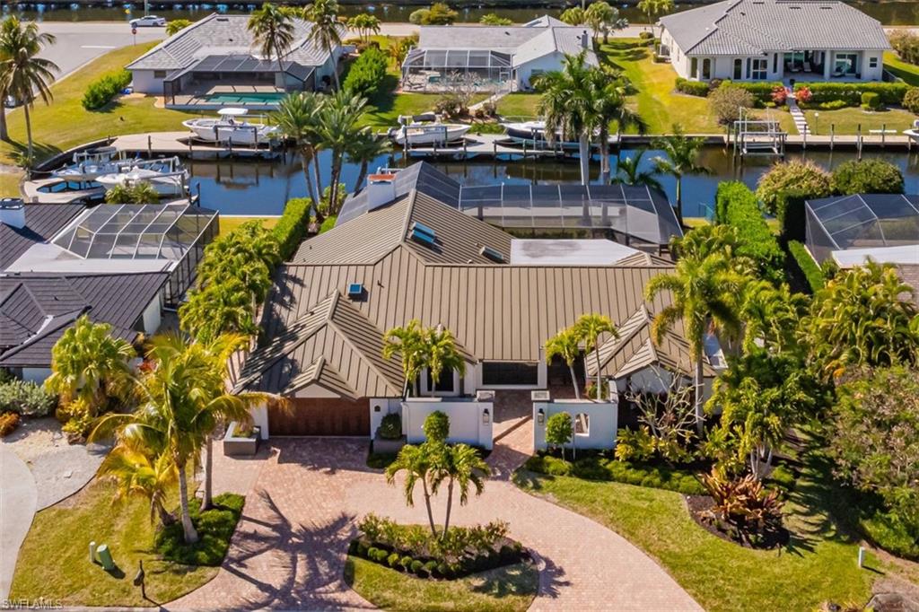 Expertly updated over the past two years, this spectacular direct-gulf-access custom home is presented for your consideration.  Situated on an oversized lot with an expansive canal view, you'll be to the open water in minutes. You’ll enjoy 2813 square feet of indoor space that includes 3 bedrooms plus a den, 3 full bathrooms, a large dining/flex space with a vaulted ceiling, and an office nook.  From the spacious outdoor living area with western exposure to the carefully curated interior spaces, you may feel as if you designed this property yourself. The home has been extensively restored and renovated – exceeding hundreds of thousands of dollars in outdoor improvements alone. You’ll find newer pool equipment and a picture-window screened lanai that frames the travertine pool deck.  The pool tile was replaced, and high-efficiency air conditioning units were installed on elevated platforms.  The home was recently painted inside and out, landscaping was added to showcase Florida’s natural beauty, and even the dock has been updated.  The installation of an $80,000 metal roof was completed in 2023, as were the addition of impact-resistant windows and exterior doors, including the garage door.The substantial list of interior upgrades is highlighted by the redesigned bathrooms, new skylights, office area with built-in desk, high-efficiency water heater, stainless steel appliances, plus granite countertops and high-end cabinetry throughout the home.Equally perfect as a year-round residence or a second home, this wonderful property can be found in the esteemed Palmetto Point neighborhood.   Palmetto Point is conveniently located near Sanibel Island and Fort Myers Beach, minutes away from countless dining and entertainment choices.  Common-sense deed restrictions strike the perfect balance between preserving the subdivision's charm and protecting homeowner rights. HOA fees are low and voluntary. Take a moment to view the 3D virtual tour, and see what sets this home apart from others. Furnishings are negotiable. Flood insurance is available, and the premium is low due to the home's favorable elevation.