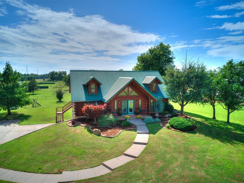 A Hidden Log Cabin Retreat right in Oklahoma City! Sitting on 2.4 fully fenced acres lies a home that feels like a world away—yet you're just minutes from top-rated schools, shopping, and major highways. This authentic log cabin is the kind of place you daydream about: rustic charm, modern comforts, and room to roam… right in the middle of town. As you turn down the drive, the handcrafted log exterior instantly slows your pace—welcoming you home to a place where sunsets are best watched from the deep back porch, and every day feels like a getaway. Step inside, and you're greeted by soaring ceilings and a loft that peeks out over the open living space below—perfect for cozy mornings and laughter-filled evenings. The heart of the home has newly updated stainless steel appliances and warm wood tones that echo the natural surroundings. The main level hosts the primary suite with its own private full bath, while two additional bedrooms and a full bath are tucked upstairs—ideal for guests, kids, or a quiet home office setup. Head down to the earth-sheltered basement where an extra 468sqft not included in square footage awaits with a versatile bonus room invites you to create: your private spa, craft room, epic storage room, or workout space. The laundry area is downstairs as well as direct access to the oversized 2-car garage, deep enough for extra storage or tandem parking for your adventure gear and comes with a storm shelter. Outside, the land speaks for itself—pipe and cable fencing encloses the property, offering a secure space for pets, hobbies, or maybe even a future garden or shop. Whether you're sipping coffee on the porch or stargazing in your own backyard, you'll feel like you’ve escaped to the country—without giving up city convenience. Zoned agricultural, this rare property is Peaceful. Completely Unexpected. This isn’t just a home—it’s a lifestyle. Come see for yourself the story waiting to be written here.