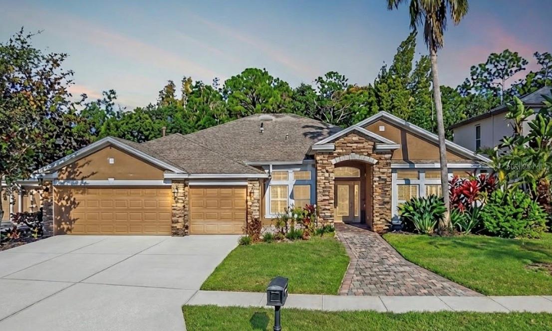 Under contract-accepting backup offers. Welcome to this magnificent estate located in the highly desirable Tampa Palms neighborhood! Roof is 3 Years Old, AC is 4 Years Old, and Water Heater is 2 Years Old. Spanning an impressive 3,040 square feet, this home offers four spacious bedrooms and three full bathrooms, providing ample space for comfort and privacy. With a large office as a bonus space! As you arrive, the inviting brick paver entryway sets the stage for the elegance that awaits inside. The interior is defined by sophisticated details, including gleaming hardwood floors that grace all five bedrooms and stunning crown molding that accentuates the formal areas.The heart of the home is designed for both entertaining and daily living. A formal dining room area provides a refined setting for dinner parties, while the dinette area near the kitchen offers a cozy spot for casual meals. The true showstopper, however, is the outdoor living space. Step outside to your own private sanctuary featuring a sparkling tropical saltwater pool with a remote that is framed by wonderful stonework. This backyard oasis backs up to a private and tranquil conservation area, ensuring peaceful views and no rear neighbors. This is a rare opportunity to own a piece of paradise in a prime location.