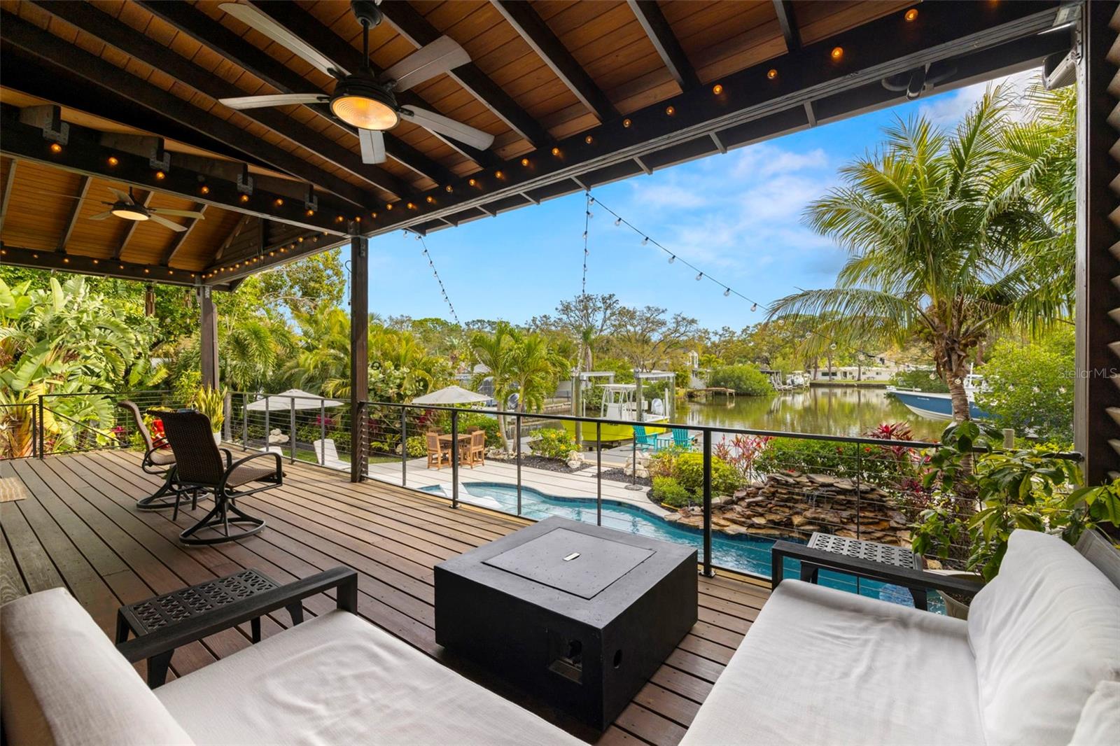 Waterfront living meets everyday comfort at 4806 W San Rafael Street. This thoughtfully designed home offers the perfect blend of function and style, with an open layout that makes the most of its stunning water views. From the moment you step inside, you'll notice the attention to detail—impact windows that bring in natural light, solid 8-foot wood doors, and custom millwork throughout. The kitchen is built for both daily life and entertaining, featuring top-of-the-line Sub-Zero and Wolf appliances, double ovens, and a six-burner gas cooktop. Soft-close cabinetry and quartz Bianco Fuma countertops add both elegance and practicality. Upstairs, the primary suite is a private retreat with custom built-in shelving in the walk-in closet and a spa-like bathroom. Every window is framed with full casings and wood sills, adding warmth and character. Outside, the backyard is built for making memories. Whether it’s relaxing by the saltwater pool and spa, gathering around the gas fire pit, or heading out on the water, this space is designed for effortless enjoyment. The recently dredged canal and brand-new dock with a 10,000 lb boat lift make it easy to get out and explore the bay. Additional storage includes approximately 600 square feet of under-deck storage—perfect for paddleboards, kayaks, and outdoor gear—as well as extra attic space above the 3 car garage. Located in one of South Tampa’s most sought-after waterfront communities, this home offers the perfect mix of tranquility and convenience. Just 10 minutes from Tampa International Airport and International Plaza, 15 minutes to Amalie Arena, Hyde Park, and Downtown Tampa, 25 minutes to St. Petersburg, 30 minutes to St. Pete Beach, and with quick access to major highways including I-275 and the Selmon Expressway, this is waterfront living at its best. Zoned for top-rated schools, including Plant High School, this home offers an exceptional lifestyle in one of Tampa’s most desirable neighborhoods. - Sellers are offering option to purchase boat with house. Schedule a private showing and a boat tour today!