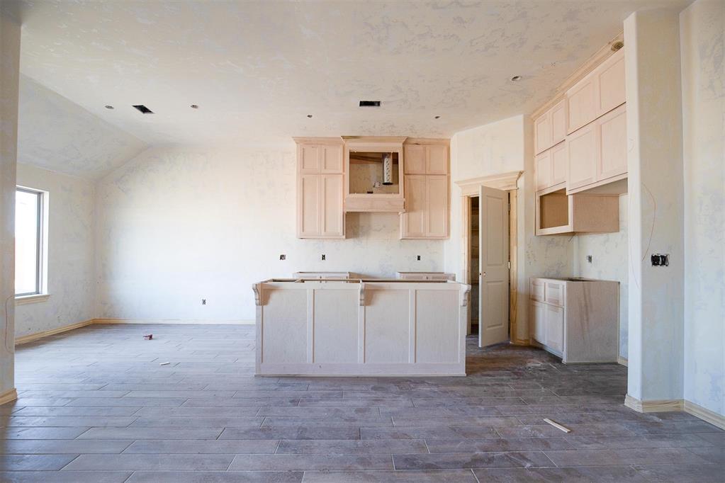 This Drake floorplan features 1,745 Sqft of total living space, which includes 1,550 Sqft of indoor space and 195 Sqft of outdoor living. This lovely home offers 3 bedrooms, 2 full bathrooms, 2 covered patios, a utility room, and a 2-car garage with an in-ground storm shelter installed. The living room presents 10' ceilings with a ceiling fan, large windows, Cat6 wiring, wood-look tile, and a stacked stone surround gas corner fireplace. The elegant kitchen features a large center island, custom-built cabinets to the ceiling, a corner pantry, stunning pendant lighting, more wood-look tile, stainless steel appliances, modern tile backsplash, and 3 CM countertops. The primary suite supports a sloped ceiling detail, windows, a ceiling fan, Cat6 wiring, and our cozy carpet finish. The prime bath holds a dual sink vanity with framed mirrors, a free-standing tub, a private water closet, tile flooring, a walk-in shower, and a HUGE walk-in closet. Head outside and enjoy the covered back patio has a wood-burning fireplace, a gas line, and a TV hookup. Other amenities include our healthy home technology, a tankless water heater, R-44 insulation, an air filtration system, and more!